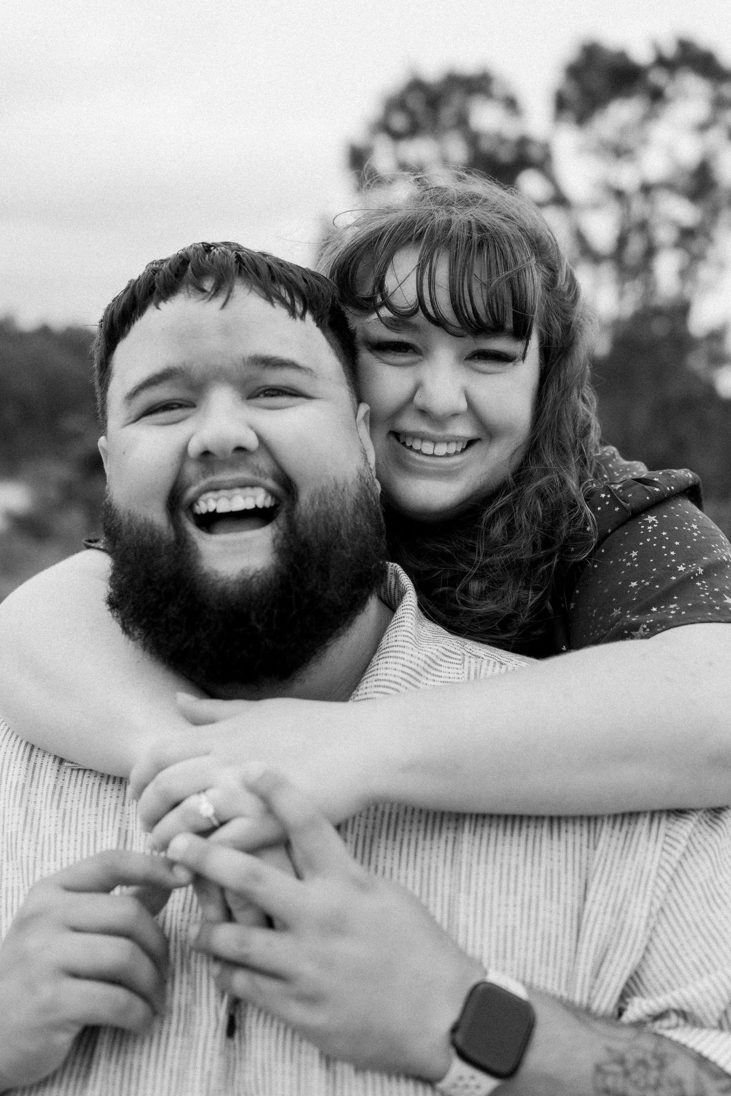 Close-up black and white portrait capturing joyful laughter and genuine emotion.