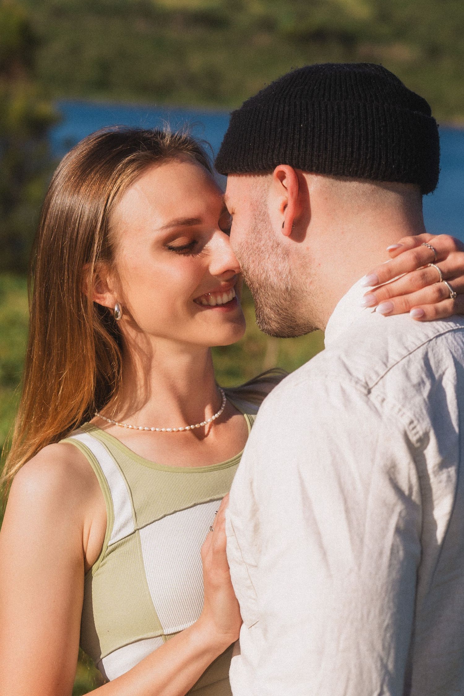 Tender romantic sequence captured in warm sunlight with natural coastal scenery.