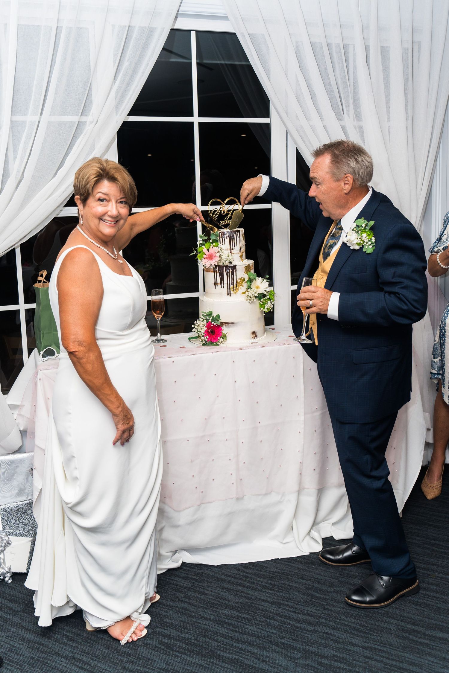 Reception venue decorated with white linens and elegant table settings.