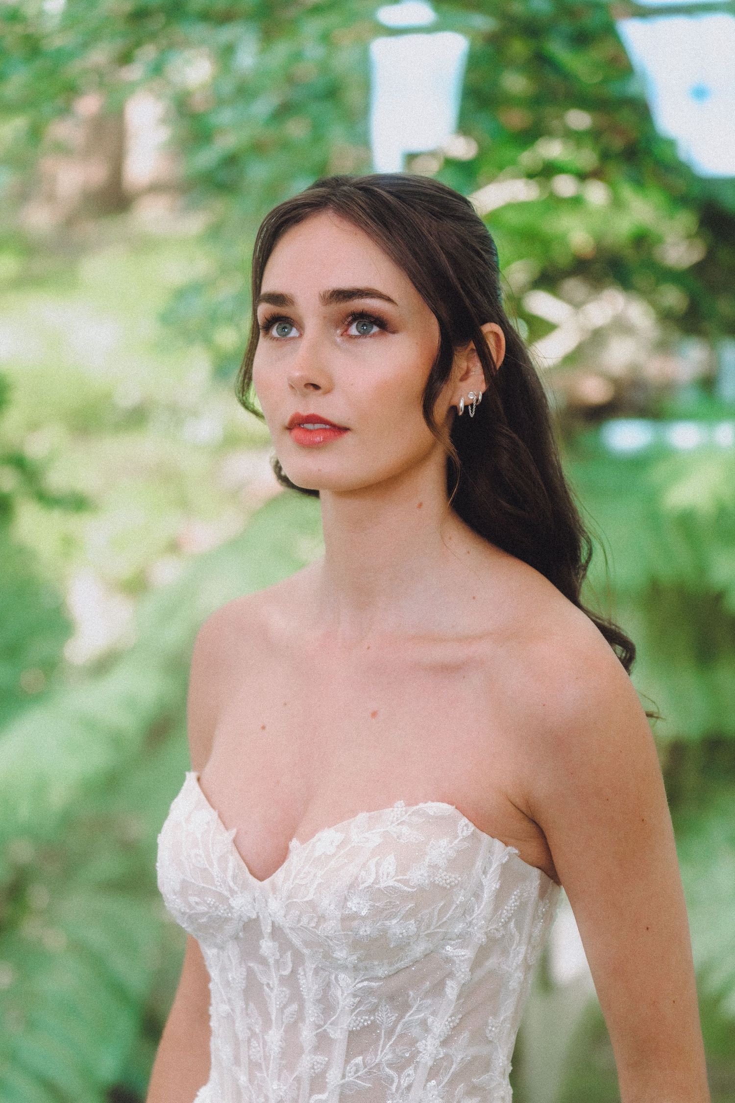 Outdoor bridal portraits featuring delicate lace bodice and natural garden backdrop.