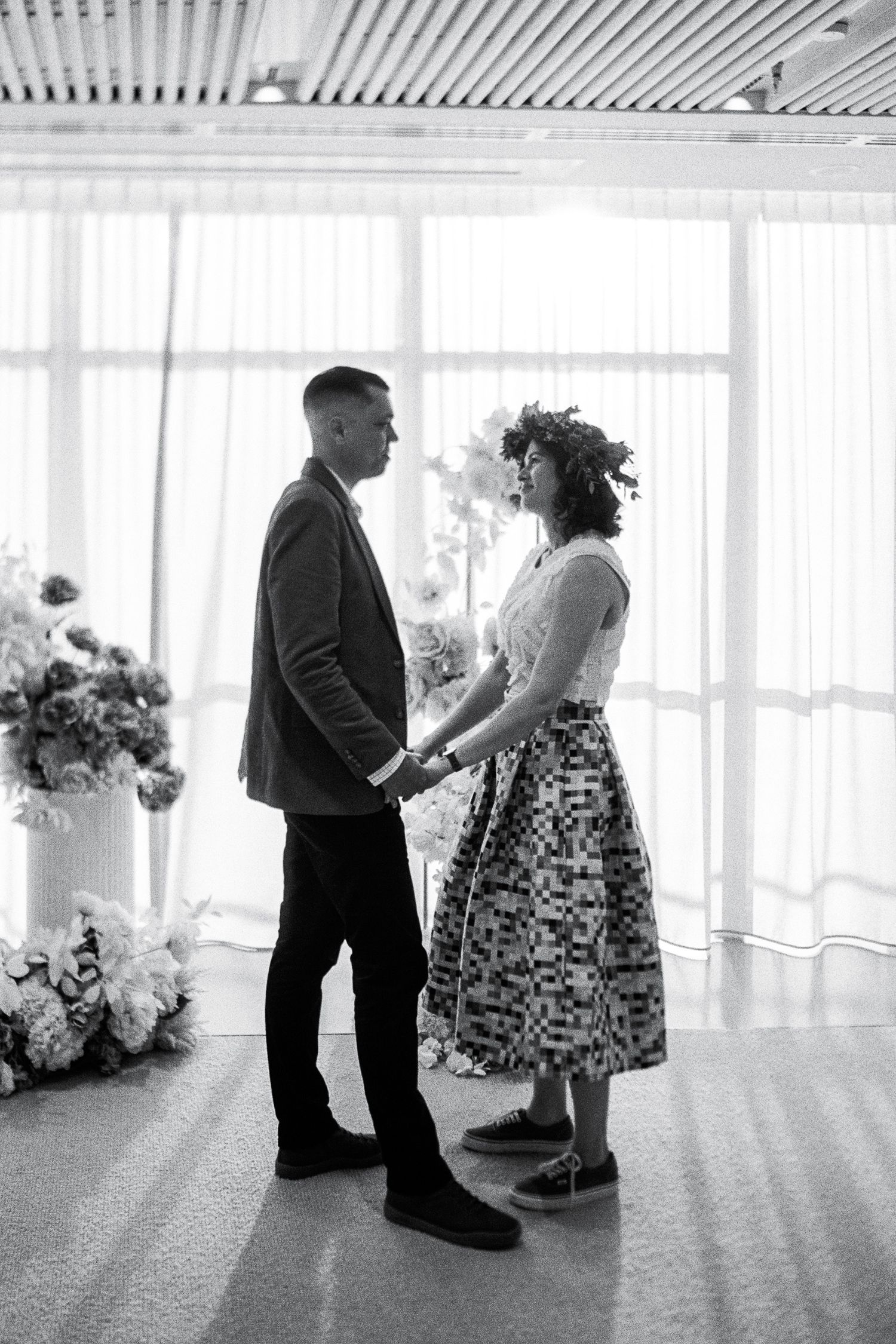 Black and white photos of couple dancing in bright sunlit room.