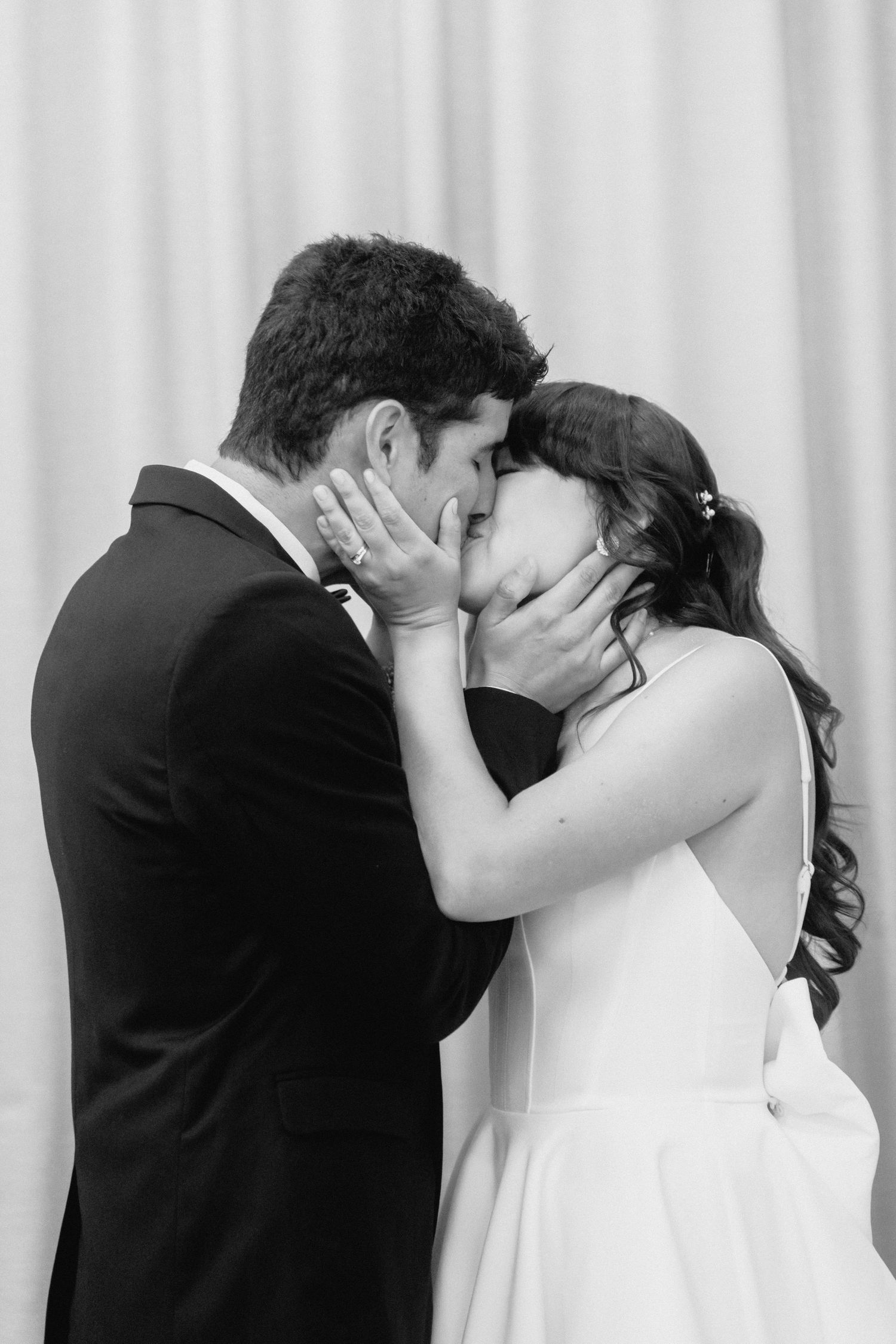 Romantic sequence of couple's first kiss during wedding ceremony.