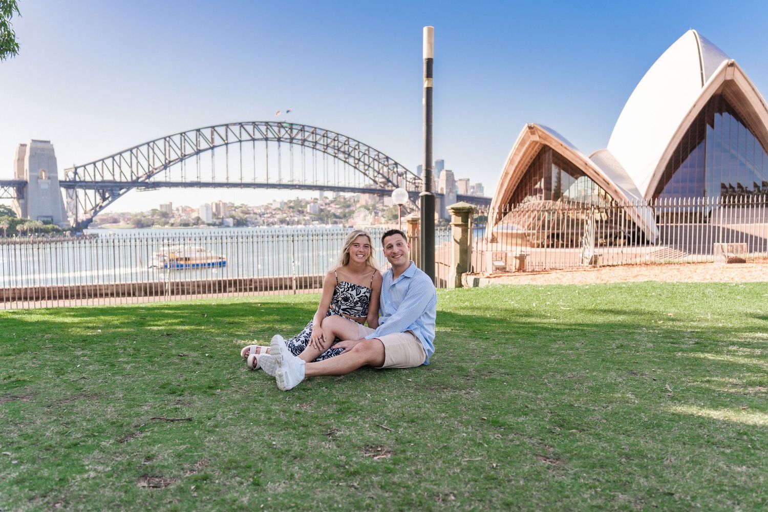 Panoramic view of Sydney Harbour showing the Opera House and Harbour Bridge on a sunny day.