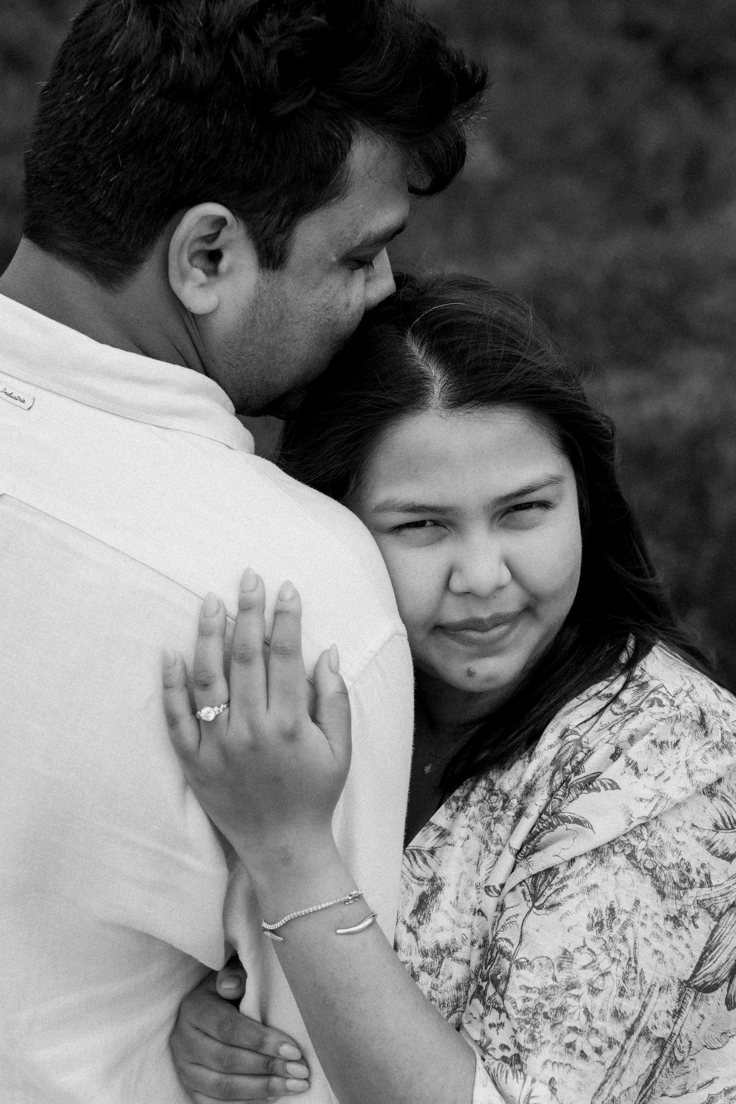 Black and white intimate portrait showing tender moments between a couple.