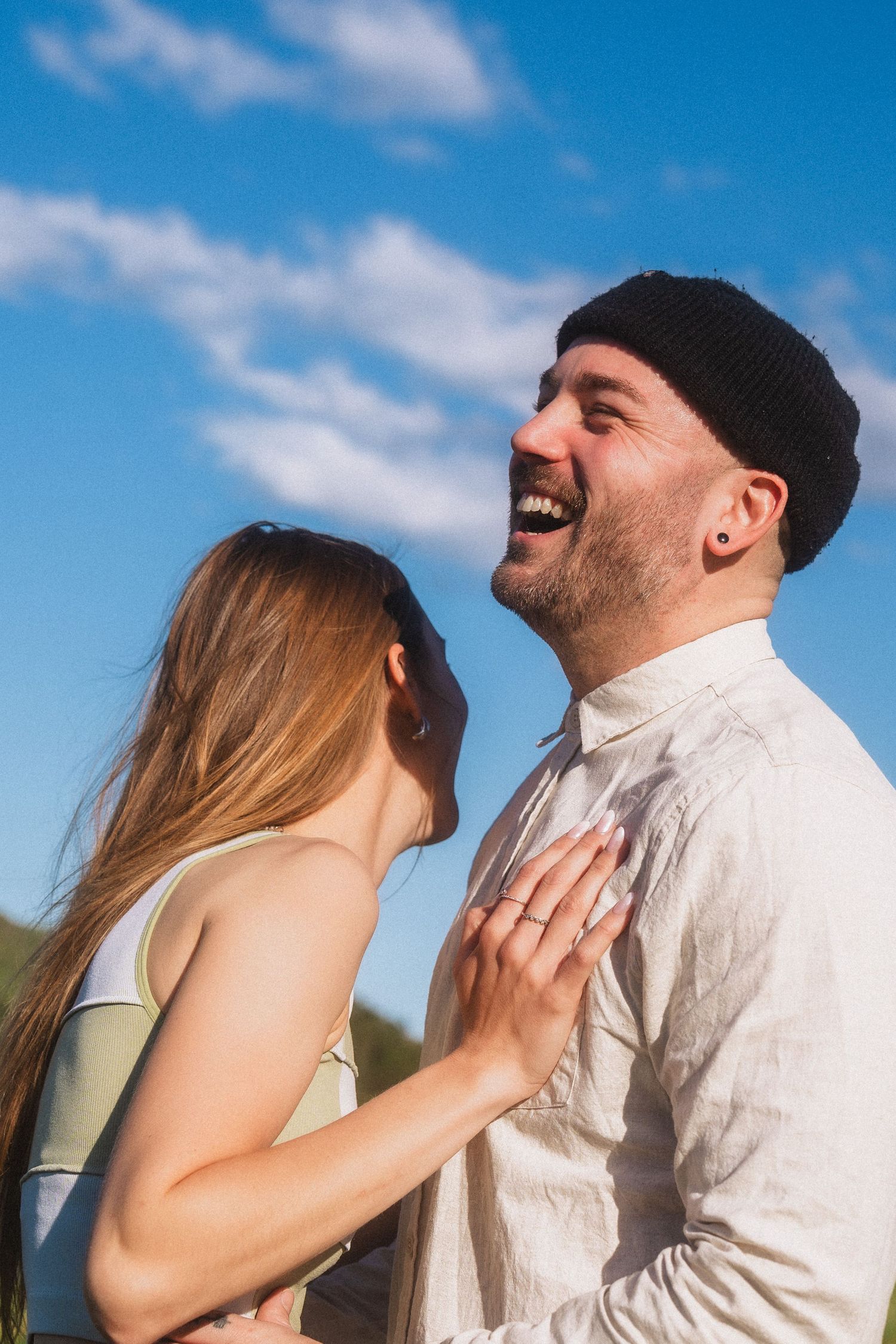 Close-up sequence of an intimate moment between a couple against a bright blue sky.