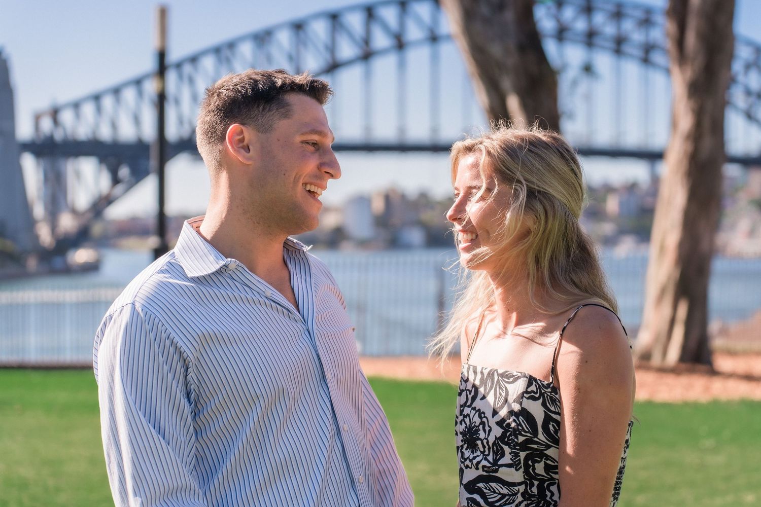 A couple shares a joyful moment together in front of the Sydney Opera House.