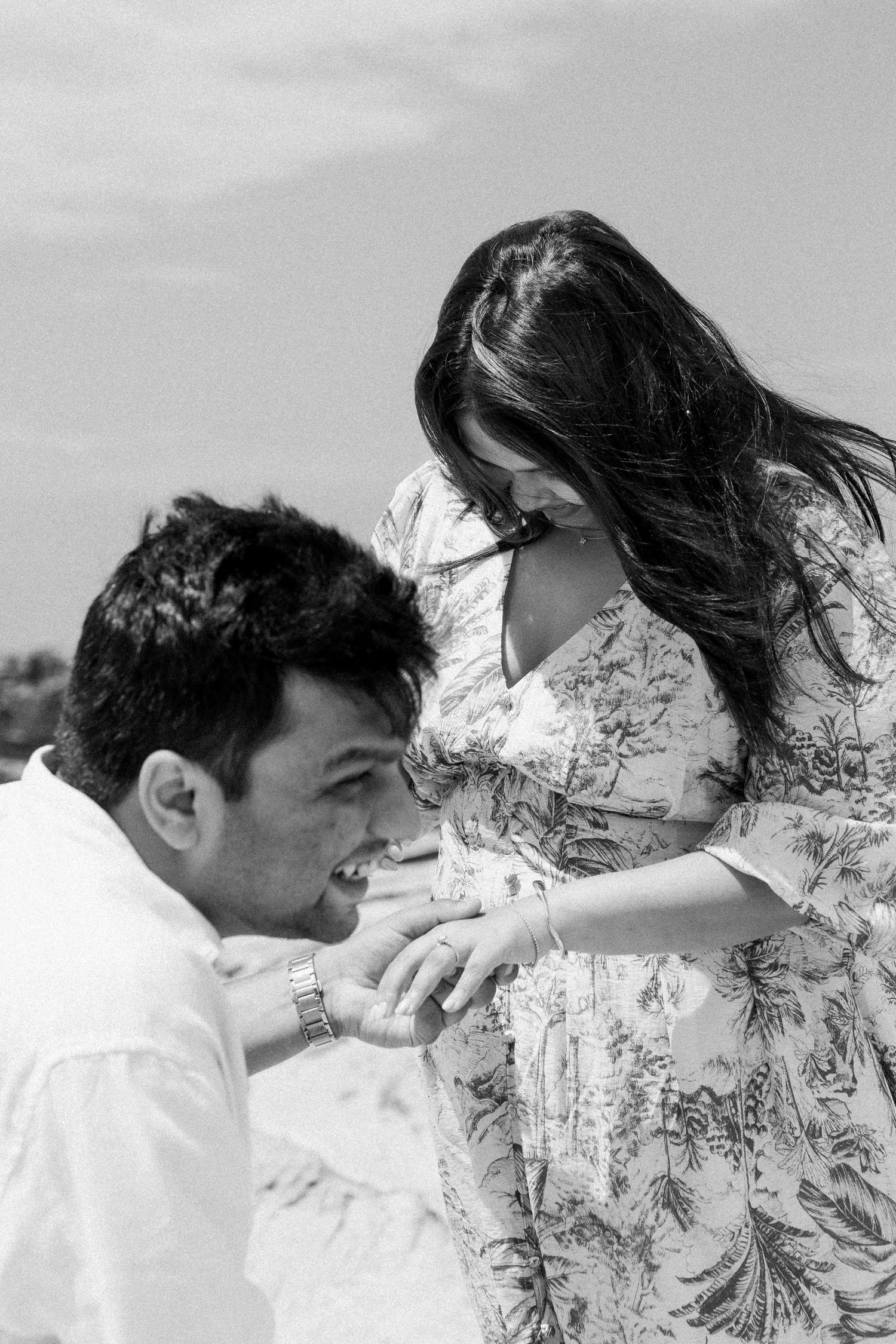 Black and white series of a couple sharing intimate moments with wind-blown hair.