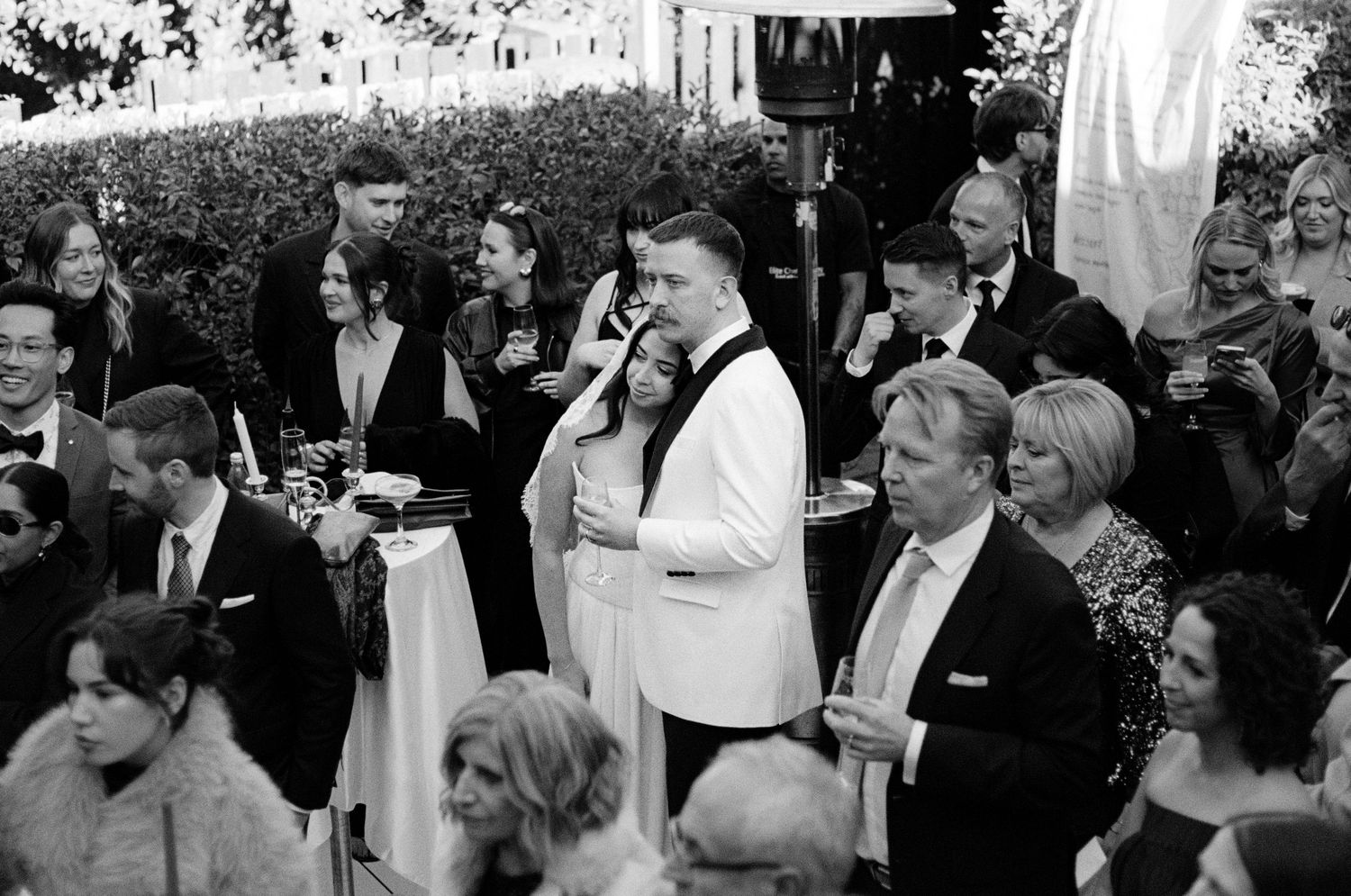 Wedding reception guests mingling at an outdoor celebration.