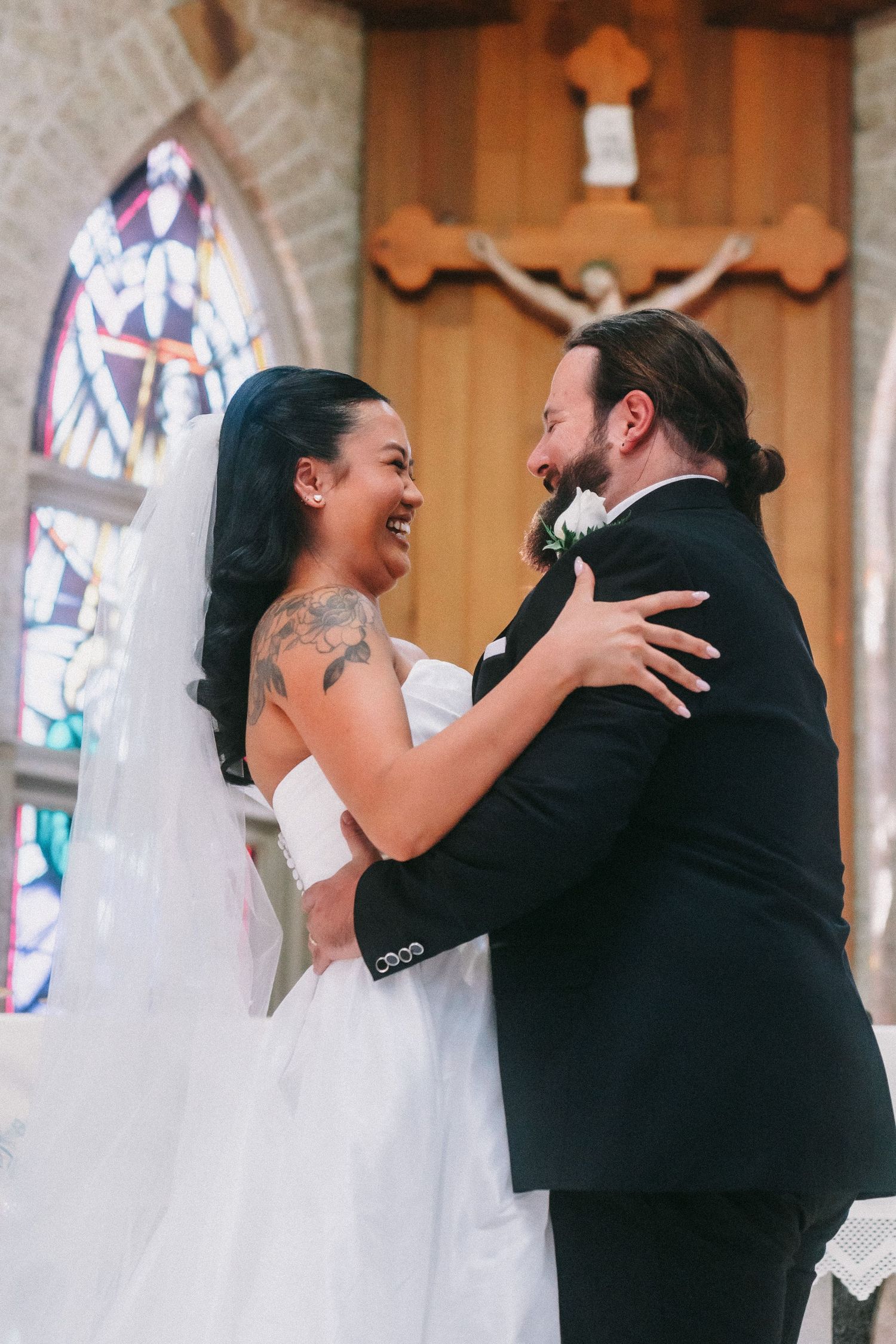 Joyful wedding celebration moment at the altar in a church.