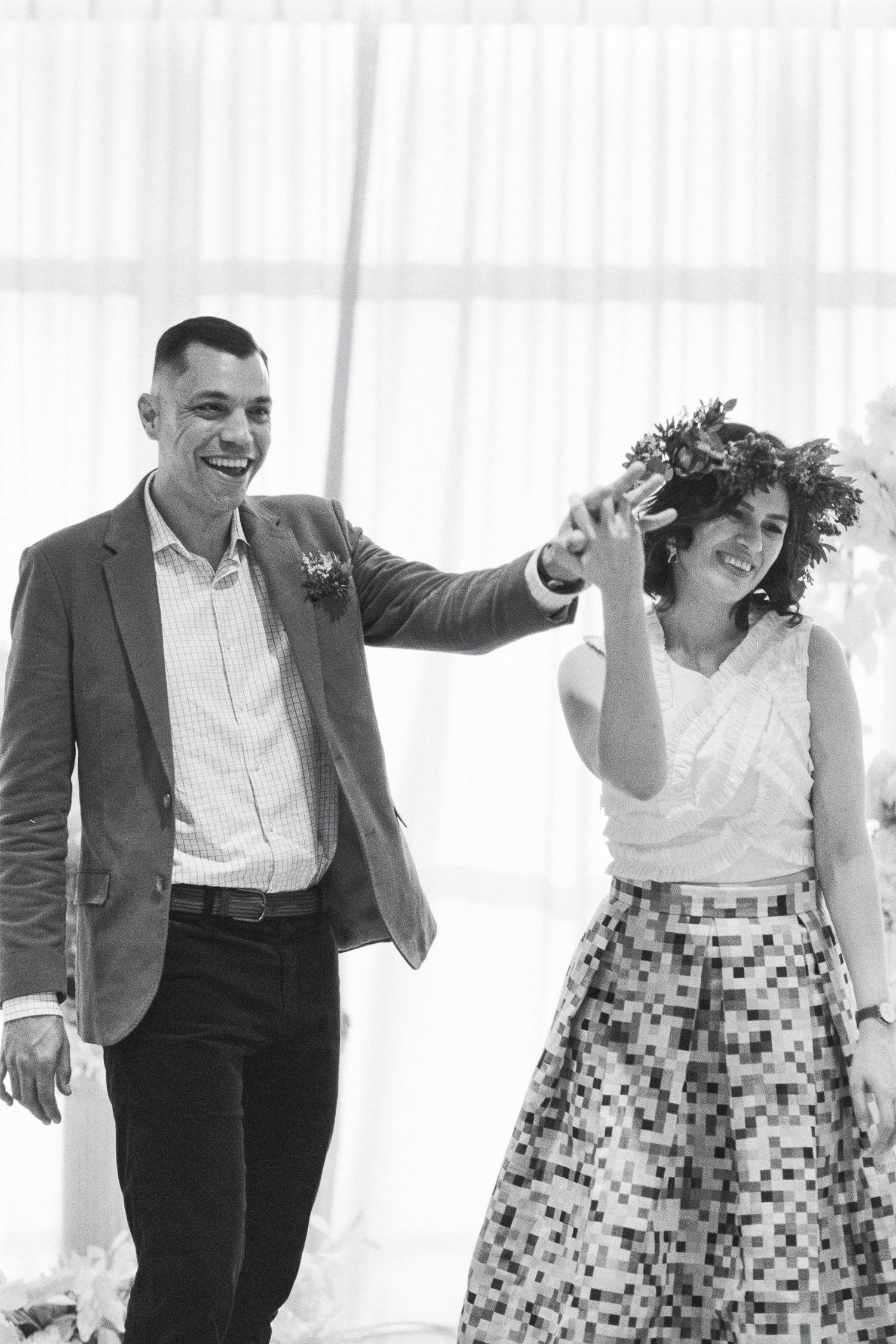 Joyful dancing sequence with laughter in bright indoor setting.