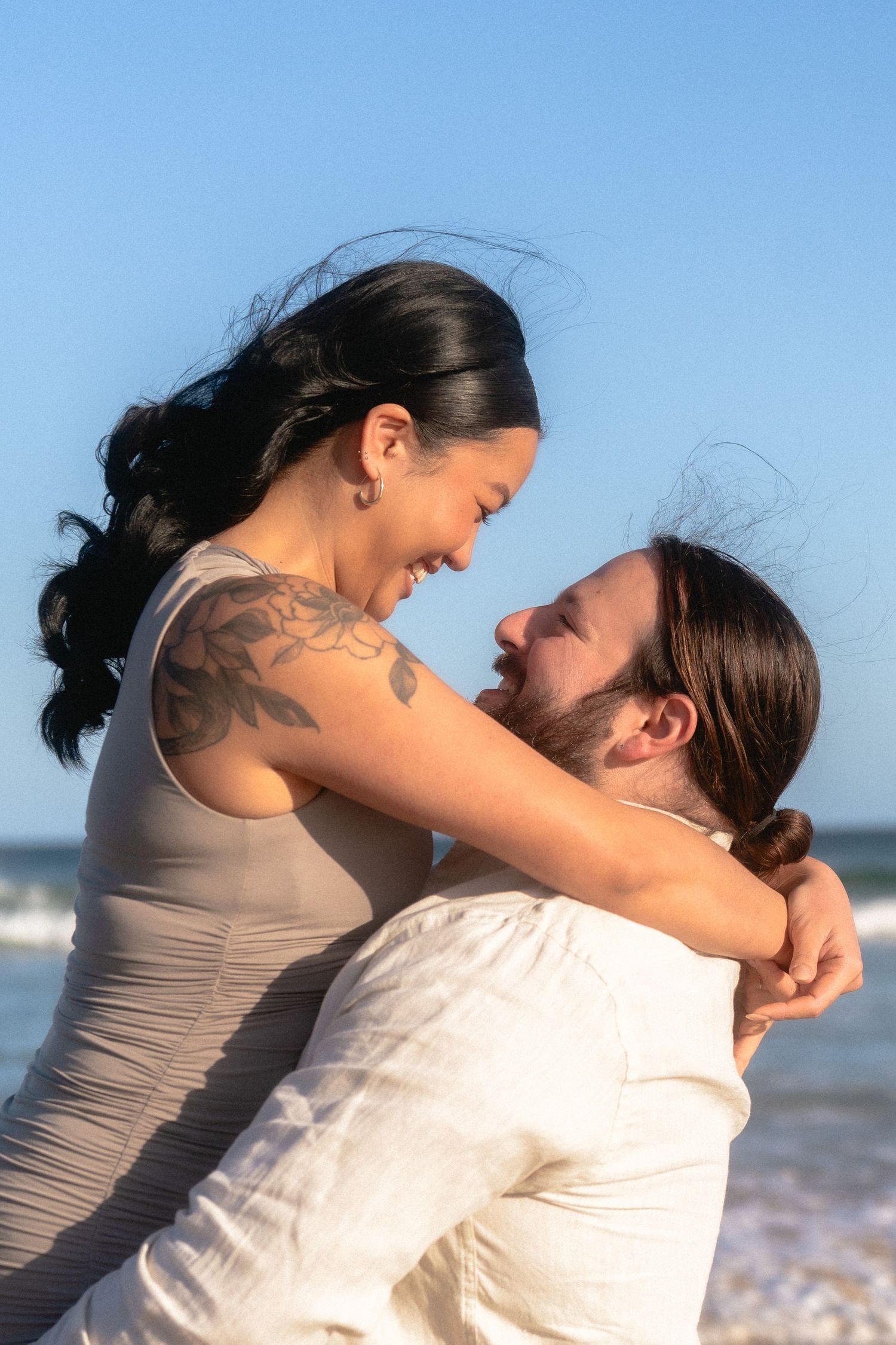 A loving couple shares an intimate moment on the beach.