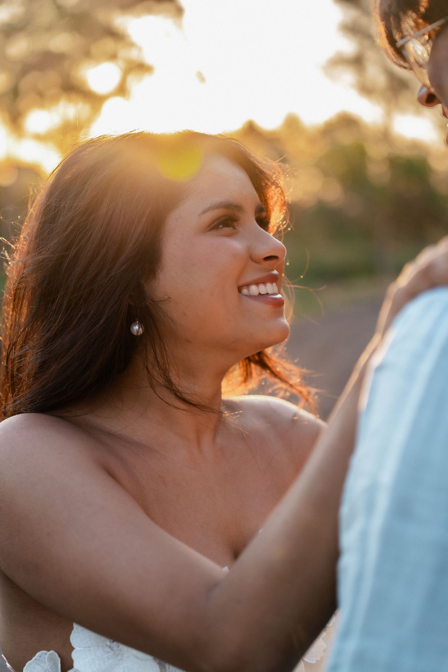 Close-up shots of a couple during golden hour with warm sunlight creating a dreamy atmosphere.