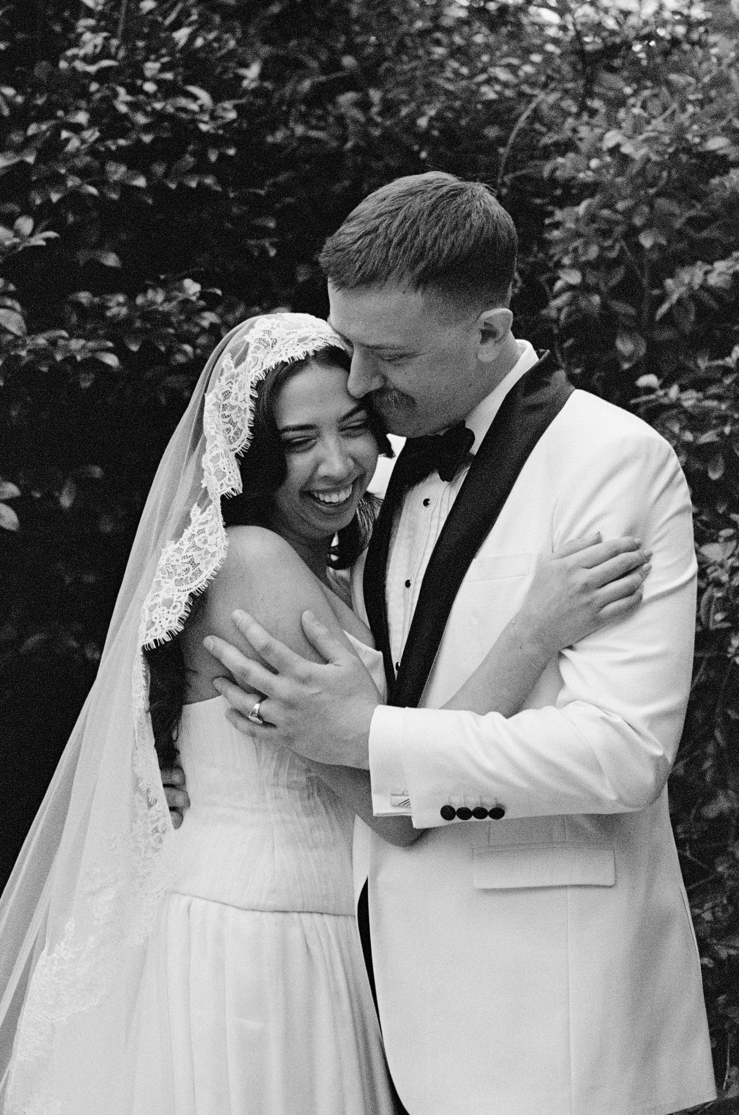 Black and white sequence of newlyweds sharing intimate moments and laughter during their wedding.