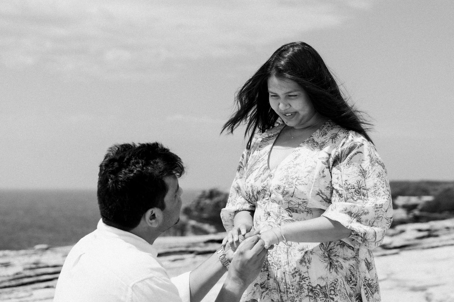 Black and white proposal sequence on coastal cliffs.
