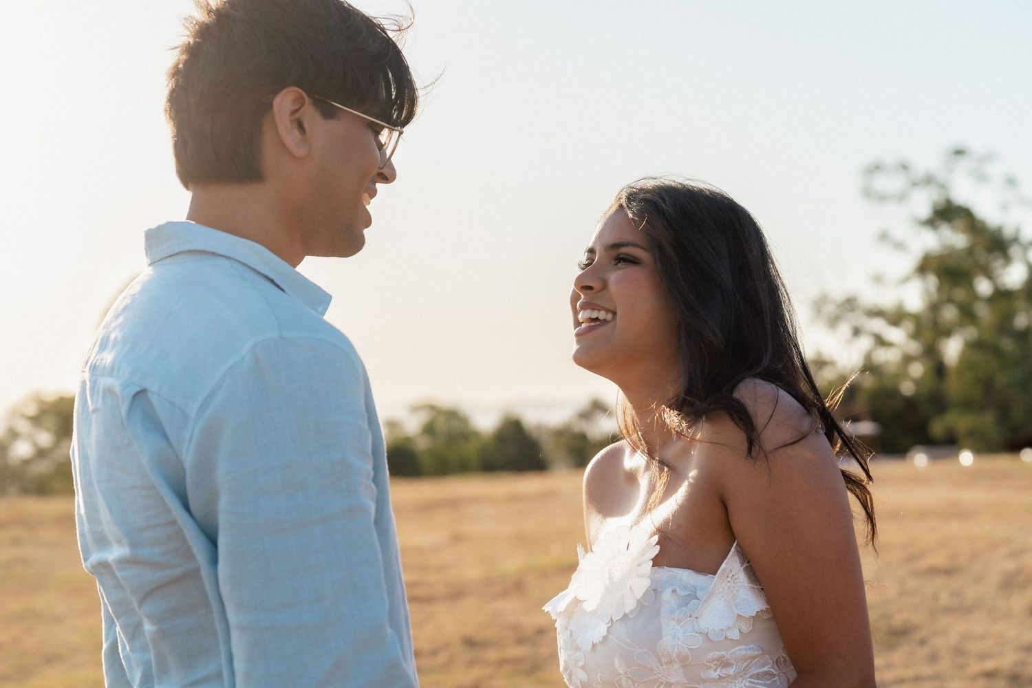 A candid moment of laughter during a sunset proposal.