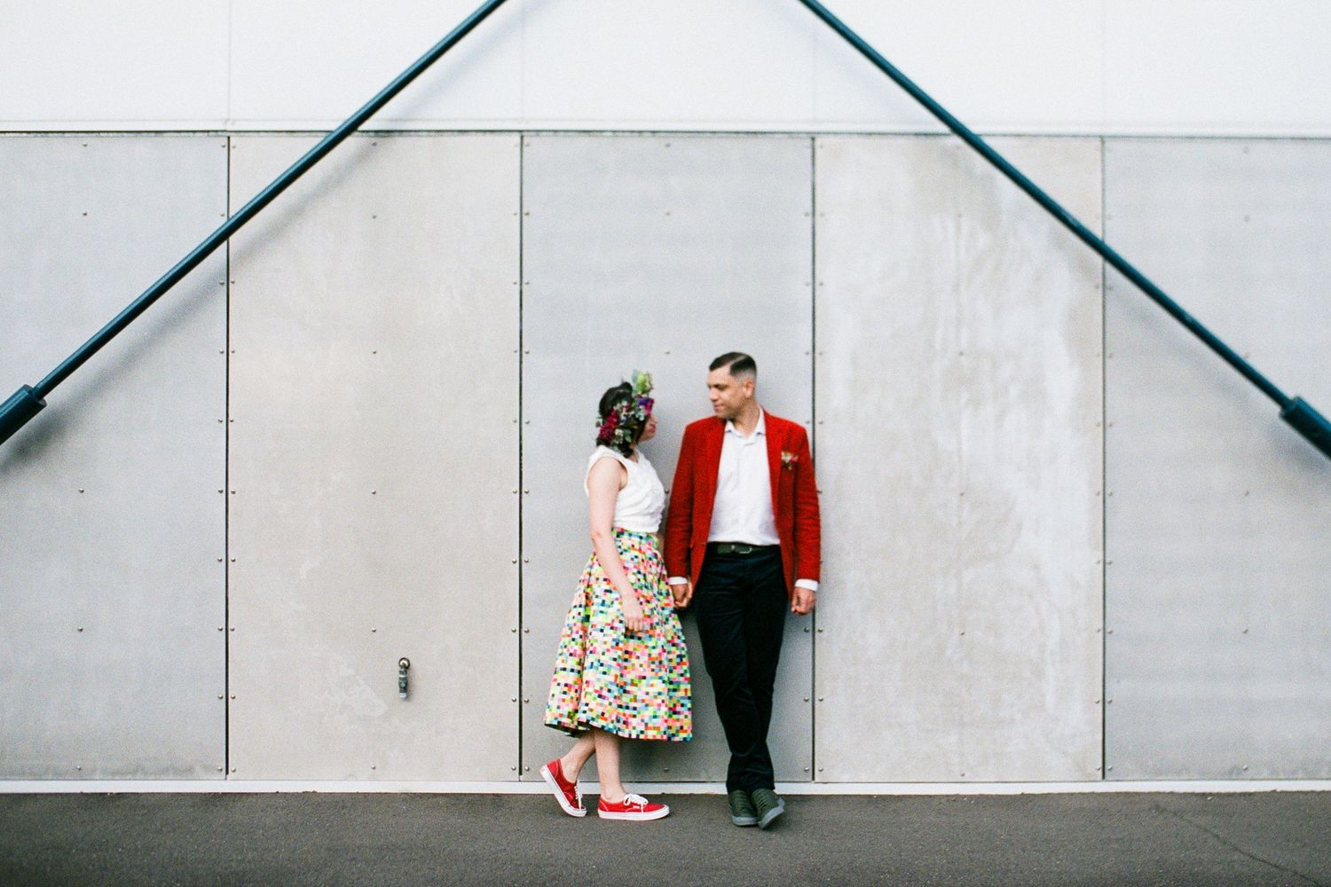 Minimalist photo series against white wall showing couple's interactions.
