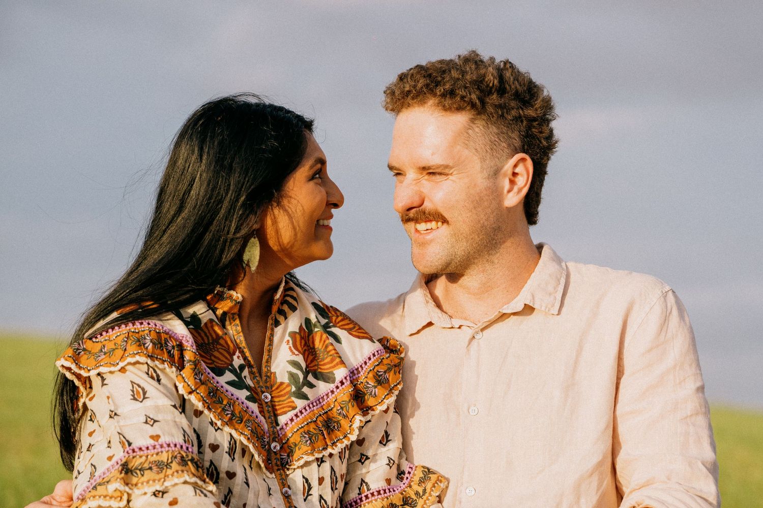 Intimate couple's portrait session in warm natural lighting.