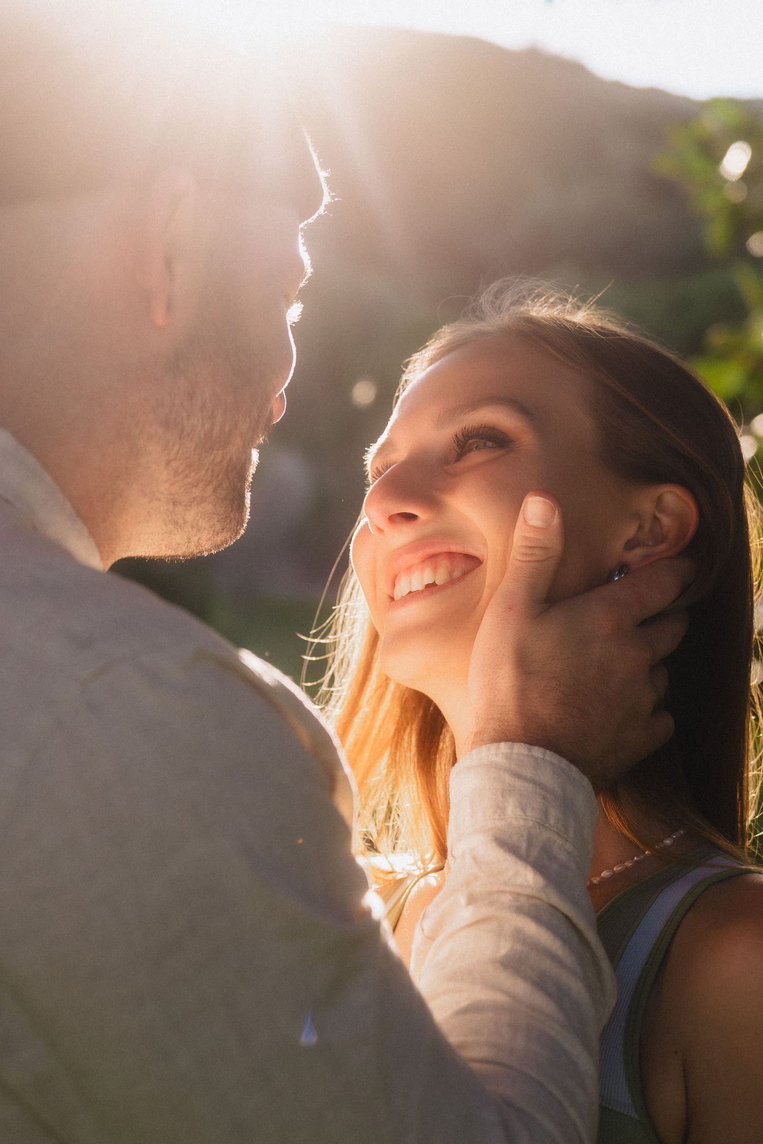 Romantic sunset portrait with golden backlighting creating a dreamy atmosphere.