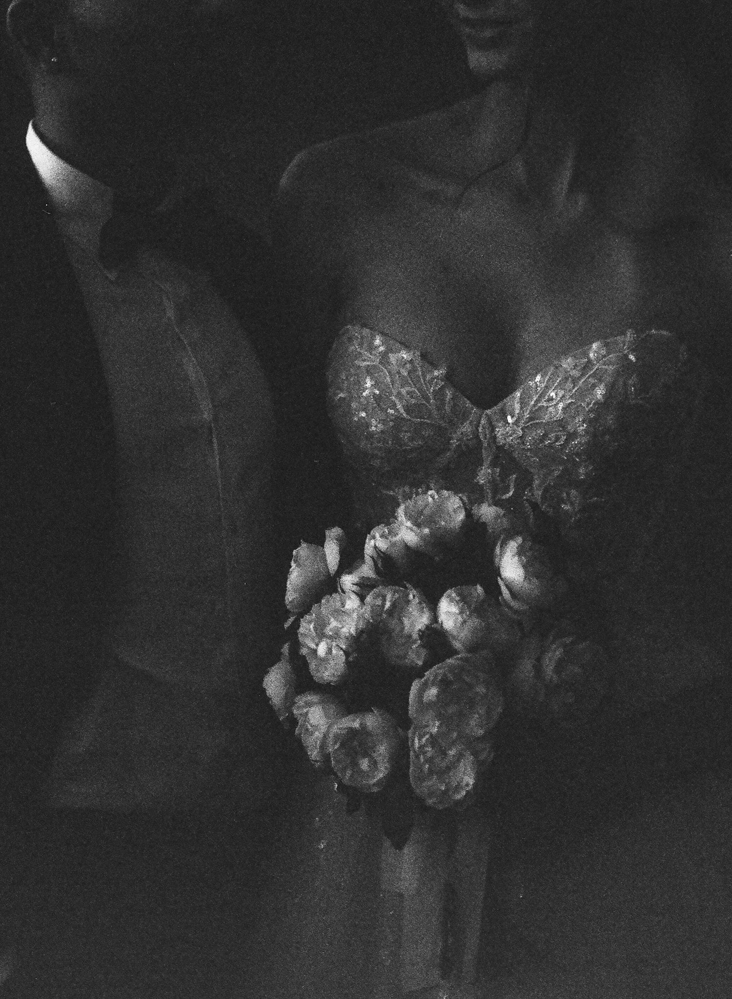 Dark and moody close-up of wedding bouquets with delicate flowers and greenery.
