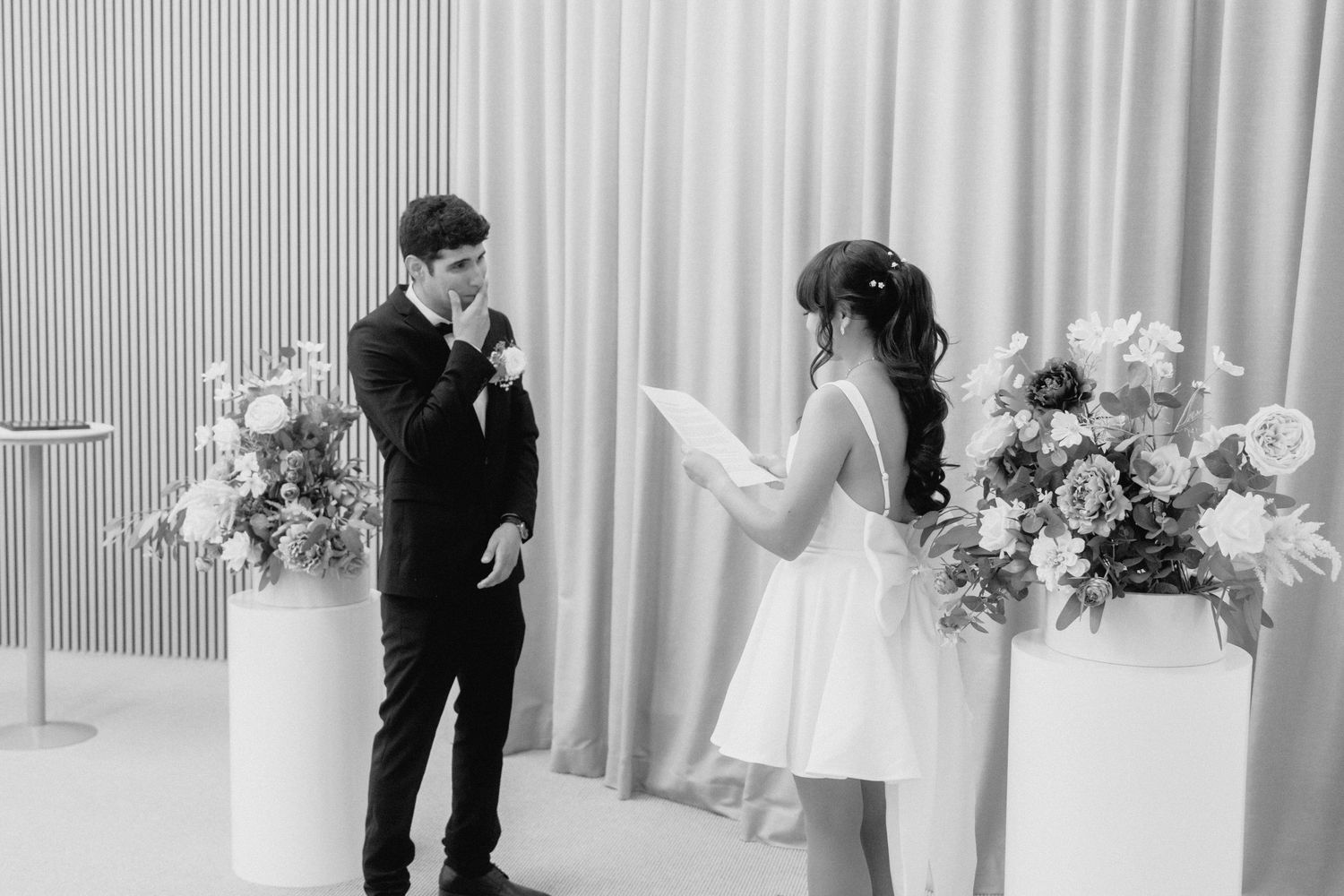 Black and white wedding ceremony sequence showing couple's emotional exchange.