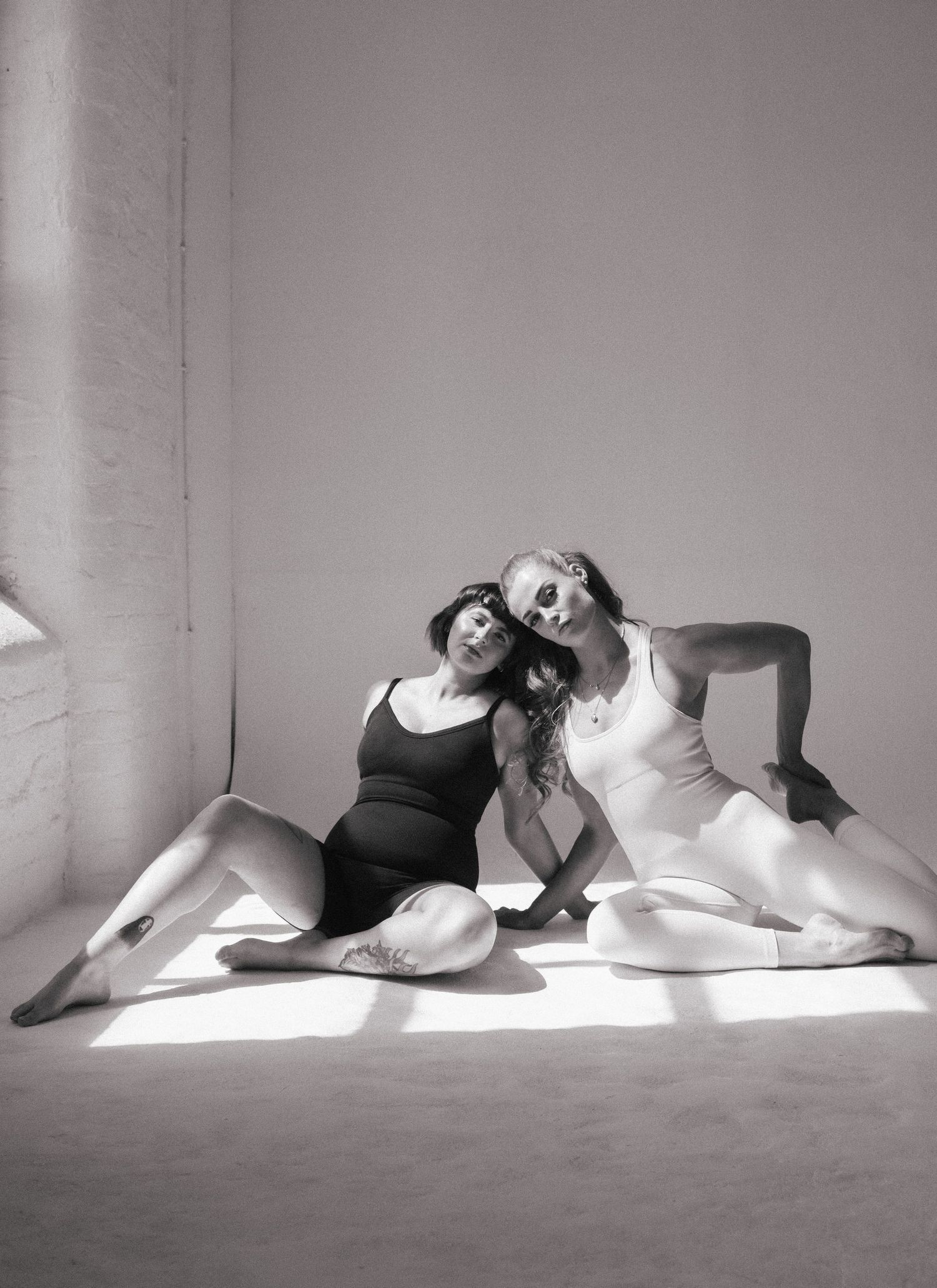Black and white artistic photo series showing graceful dance movements on a light background.