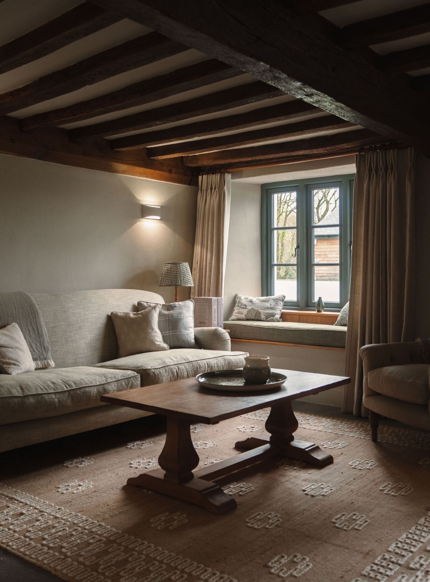 Minimalist loft bedroom interior with exposed beams and natural lighting.