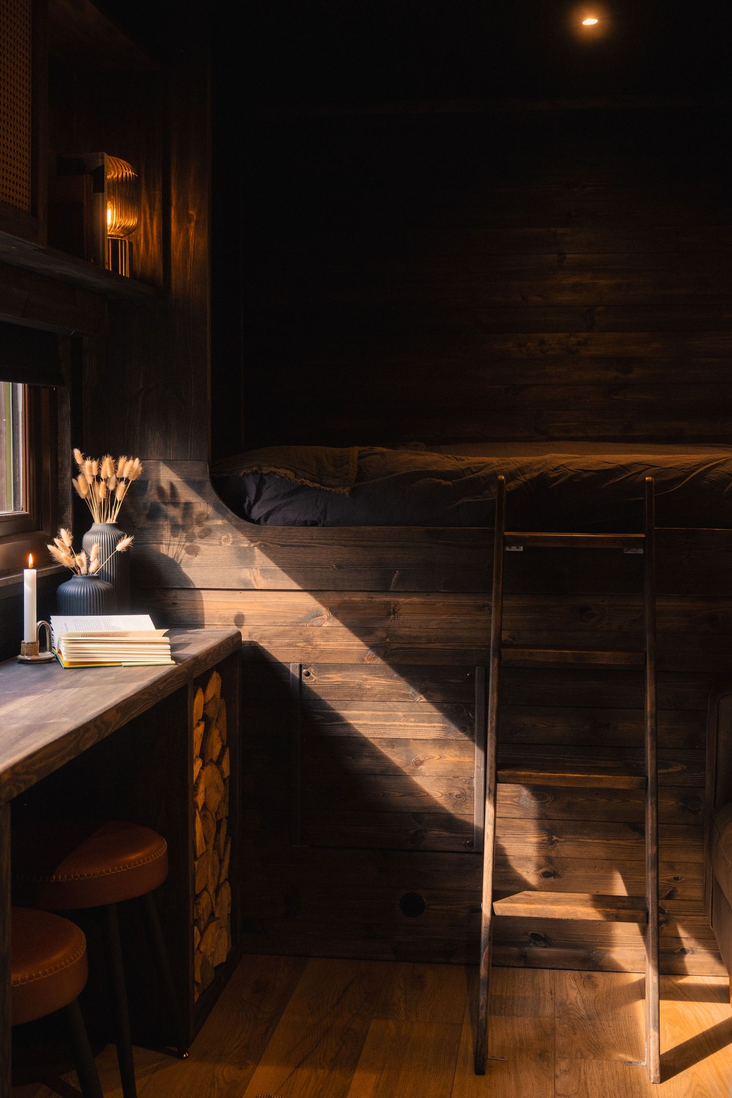 Sunlight streaming through wooden beams creating dramatic shadows in a rustic interior.