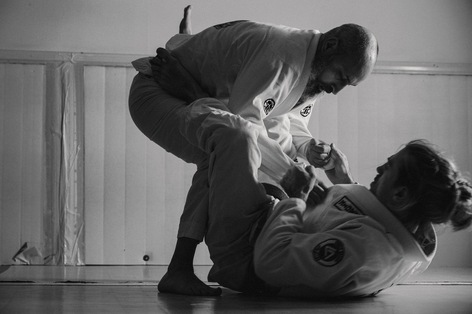 A sequence of black and white photos showing a martial arts practitioner demonstrating grappling techniques.