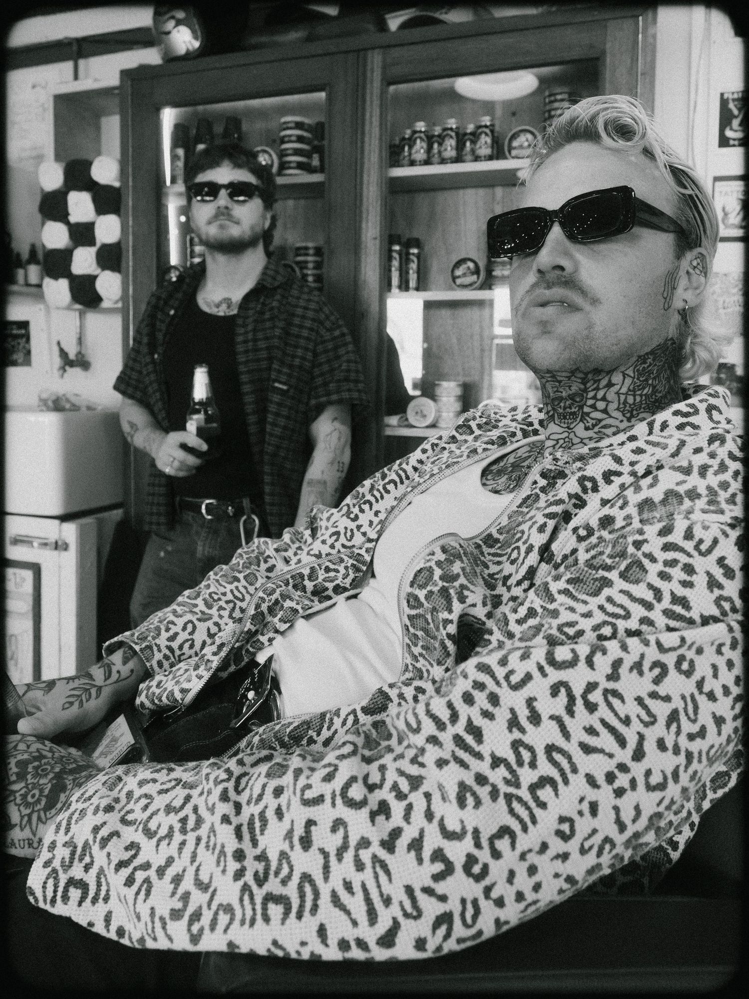 A person wearing a leopard print jacket and sunglasses reclines back in a series of sequential photos.