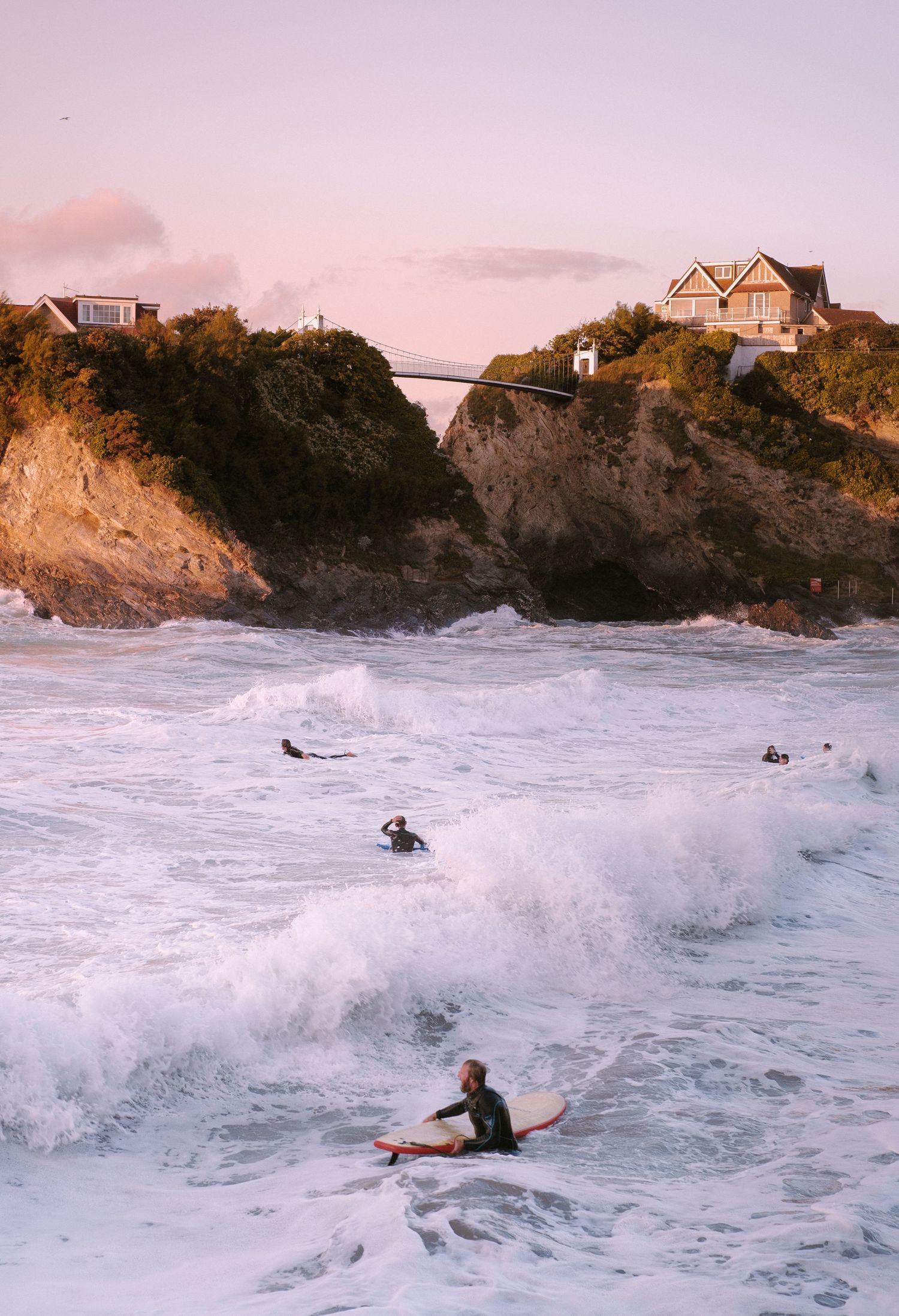 local surfers in newquay on a large wave day in the bay