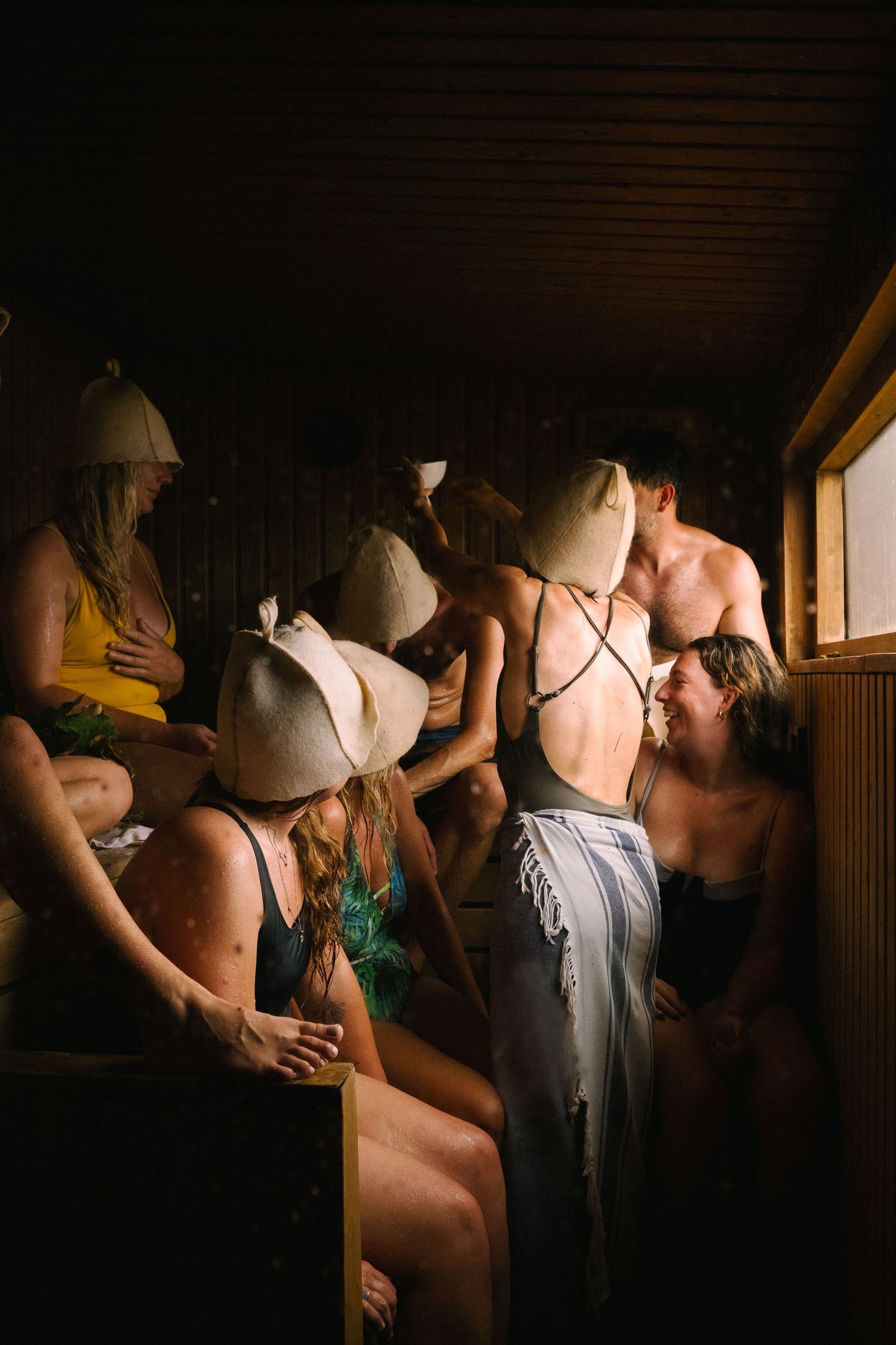 Group of people in intimate gathering with dramatic lighting. sauna