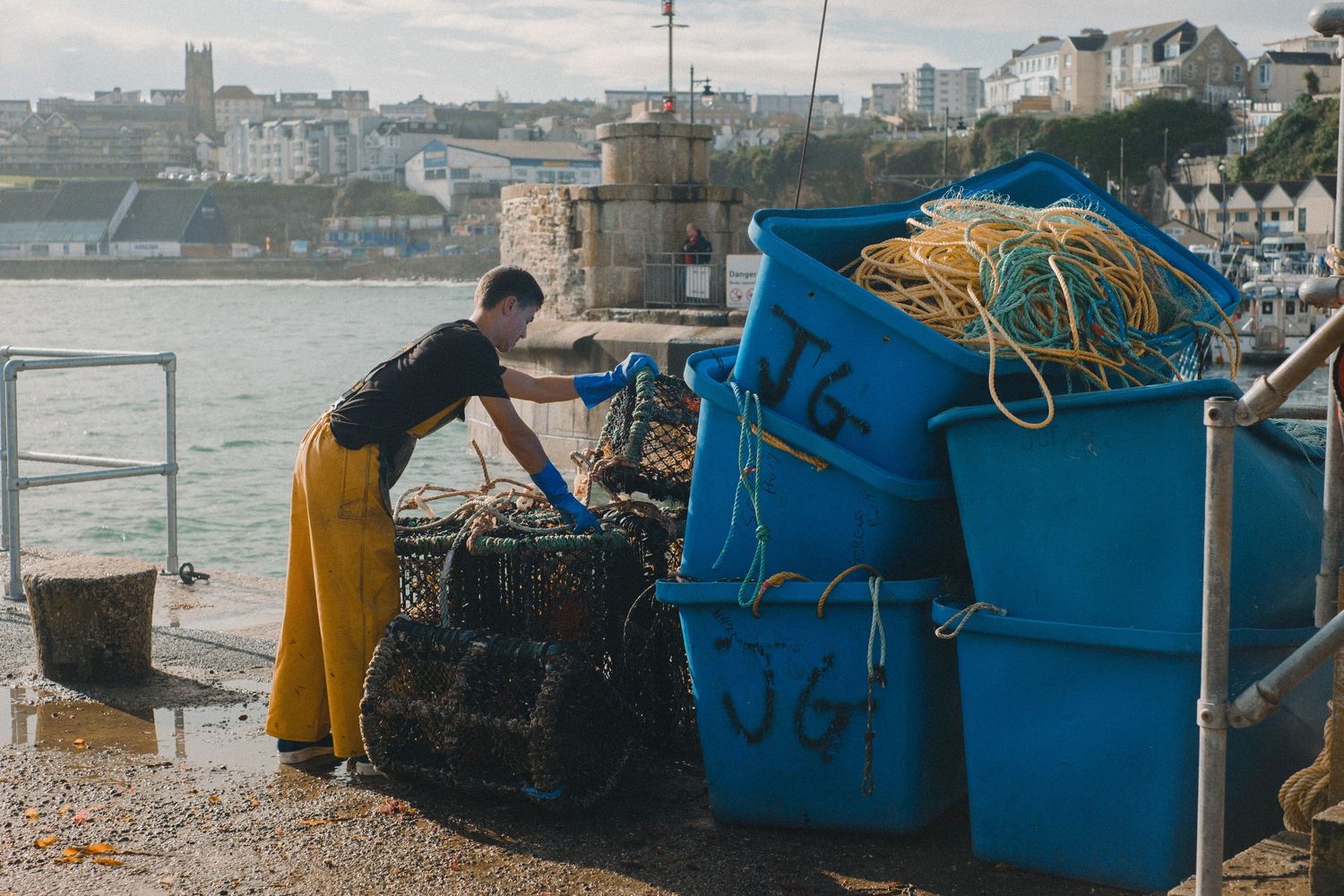 fishermen in cornwall cleaning their equipment