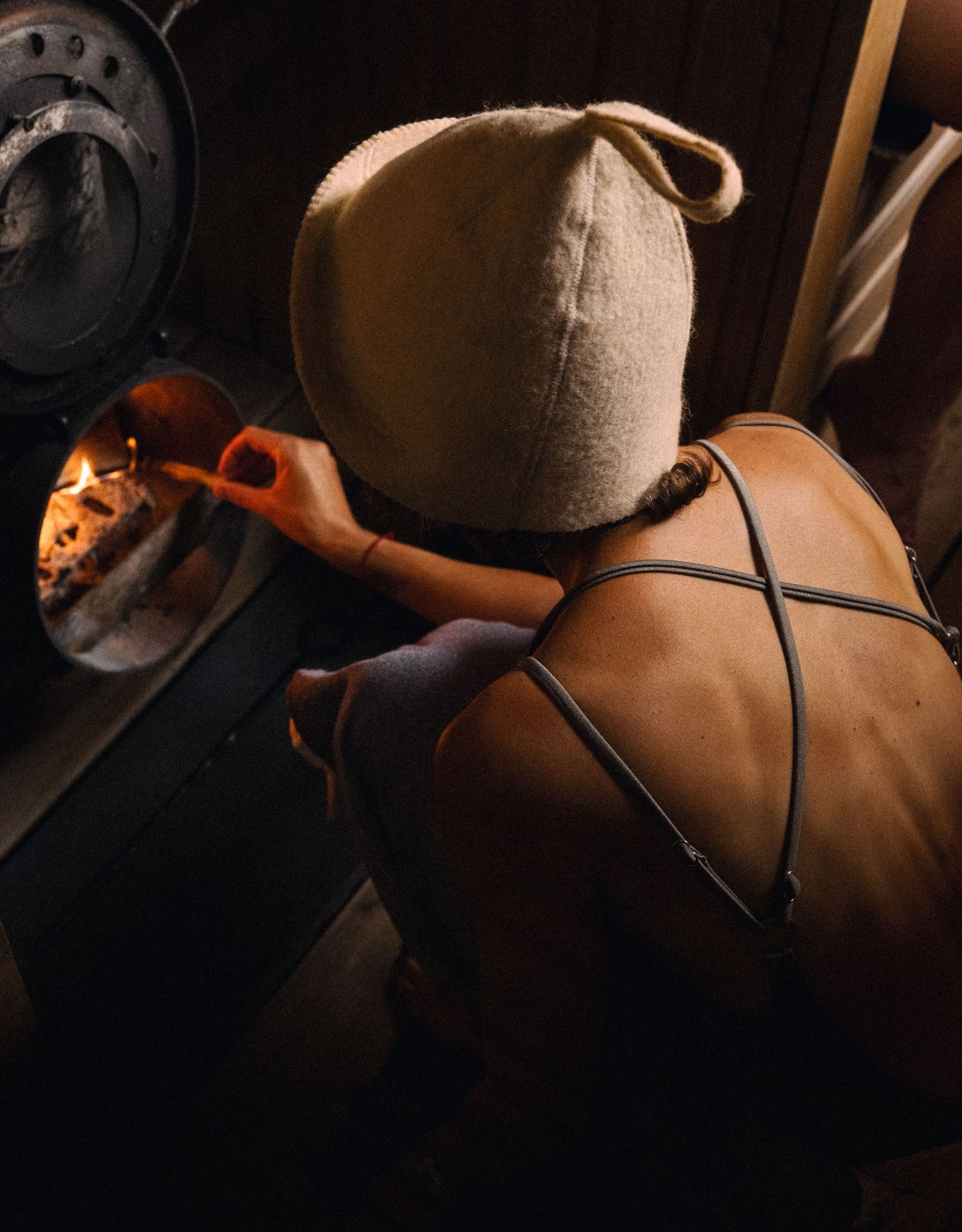 Artistic low-light photo showing bare shoulders with straps. sauna