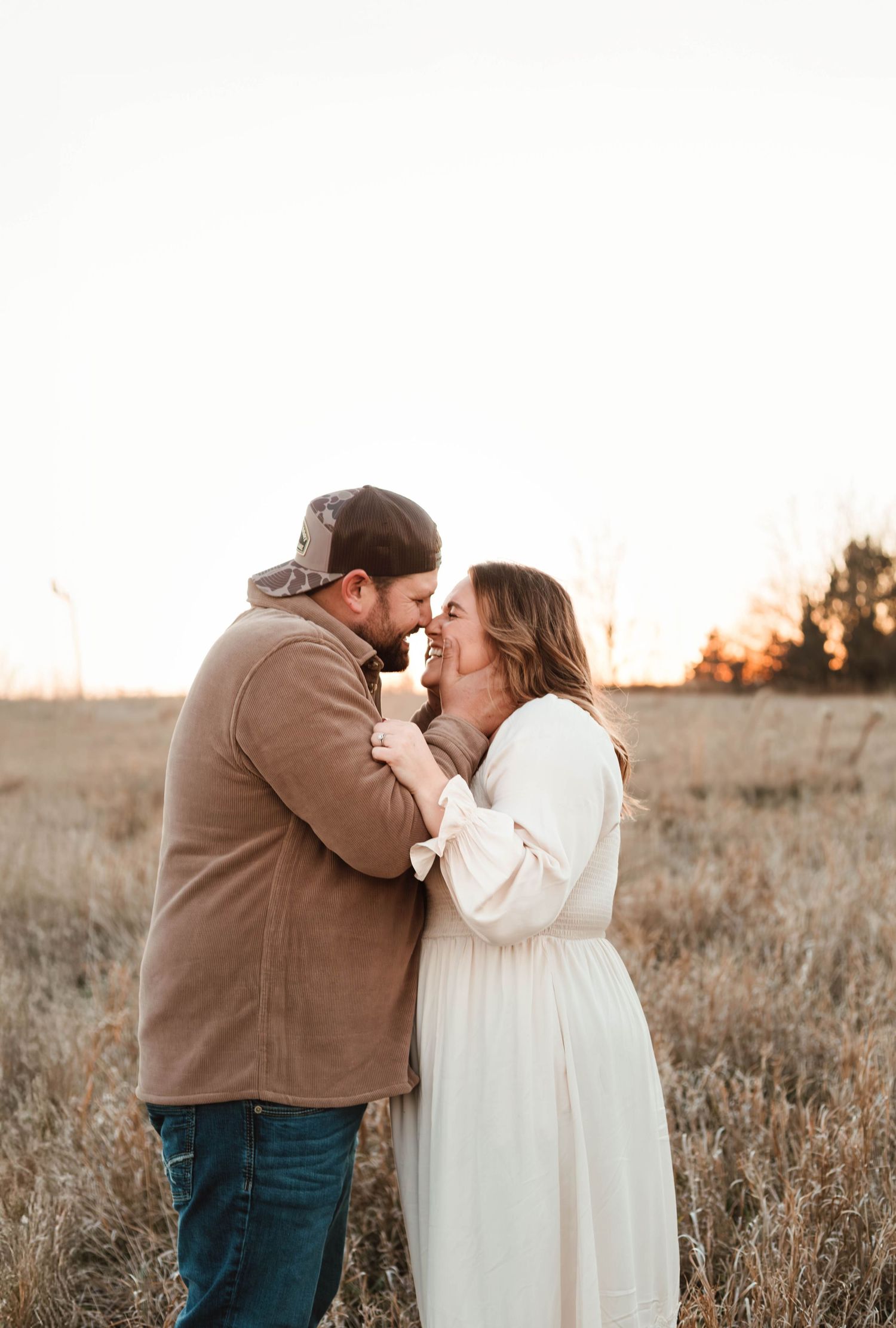 Couple kissing in grass field southeast minnesota