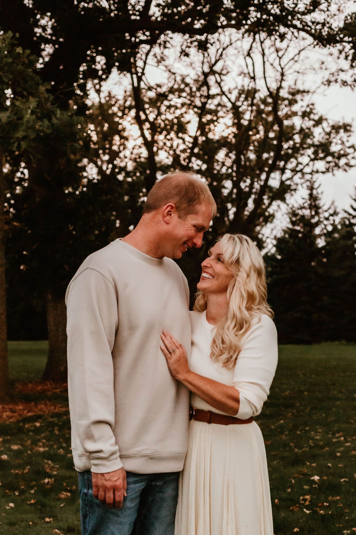 Couple looking at each other in field southeast minnesota