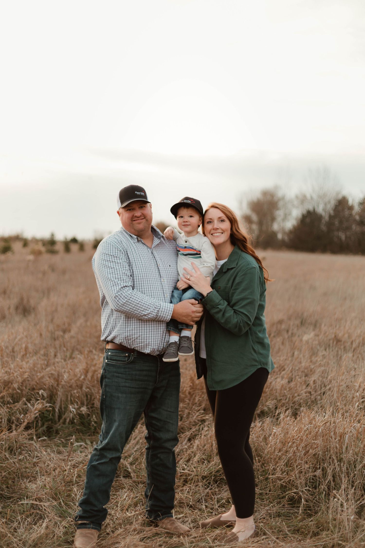 Family of 3 in grassy field Southeast Minnesota