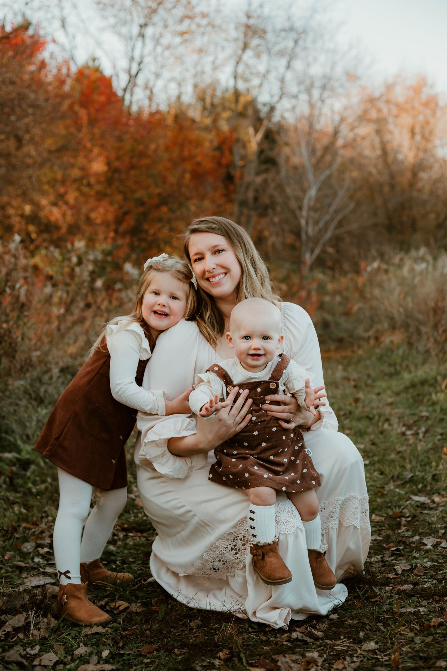 Mom and daughters in grassy field Southeast Minnesota