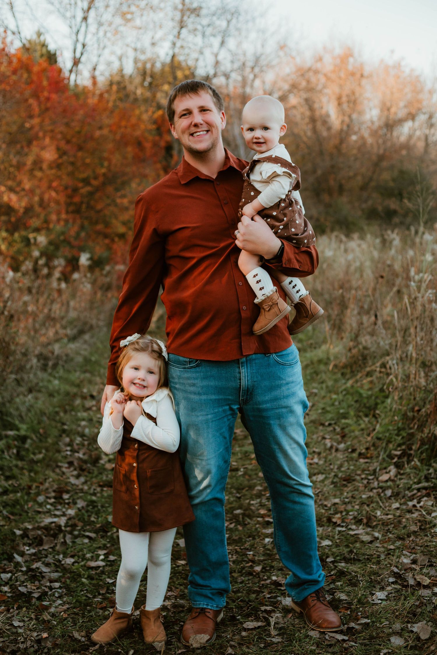 Dad and daughters in grassy field Southeast Minnesota