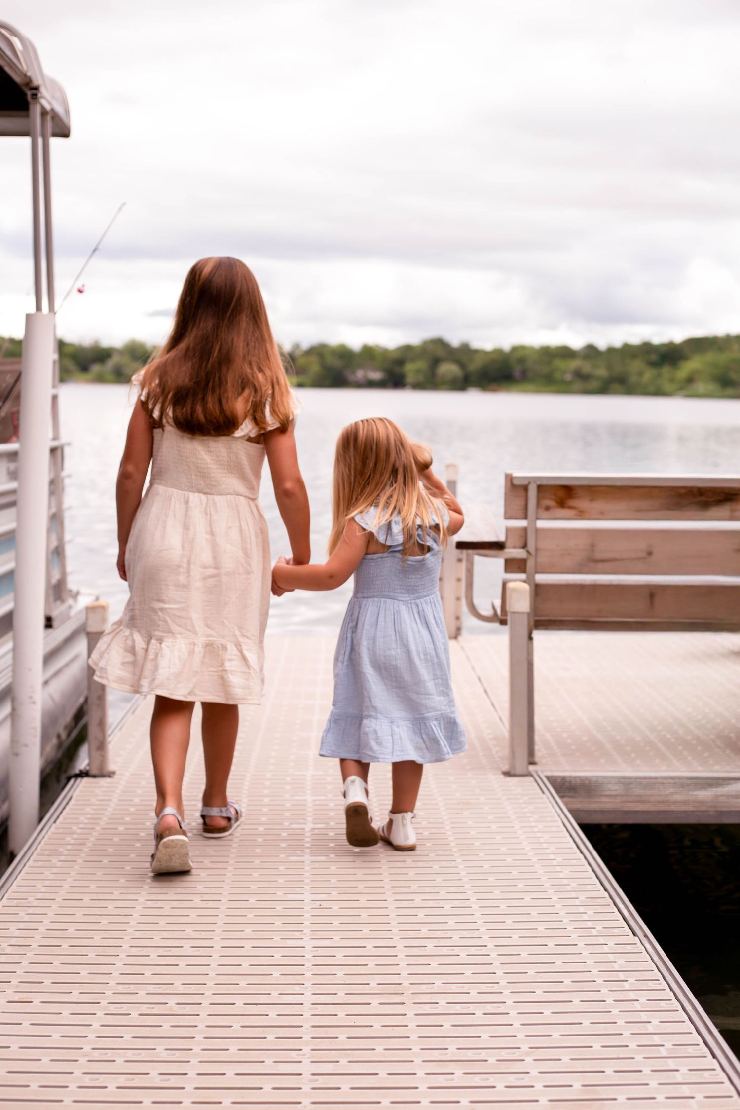 Two girls walking on dock Minnesota