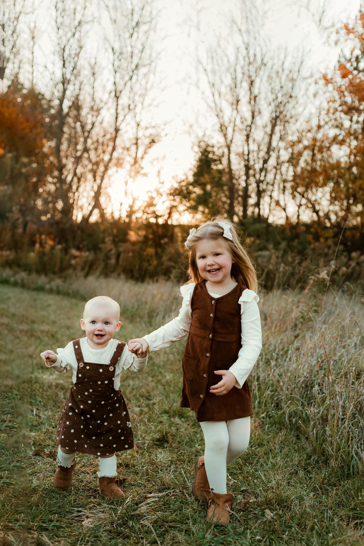 Sisters running in grassy field Southeast Minnesota