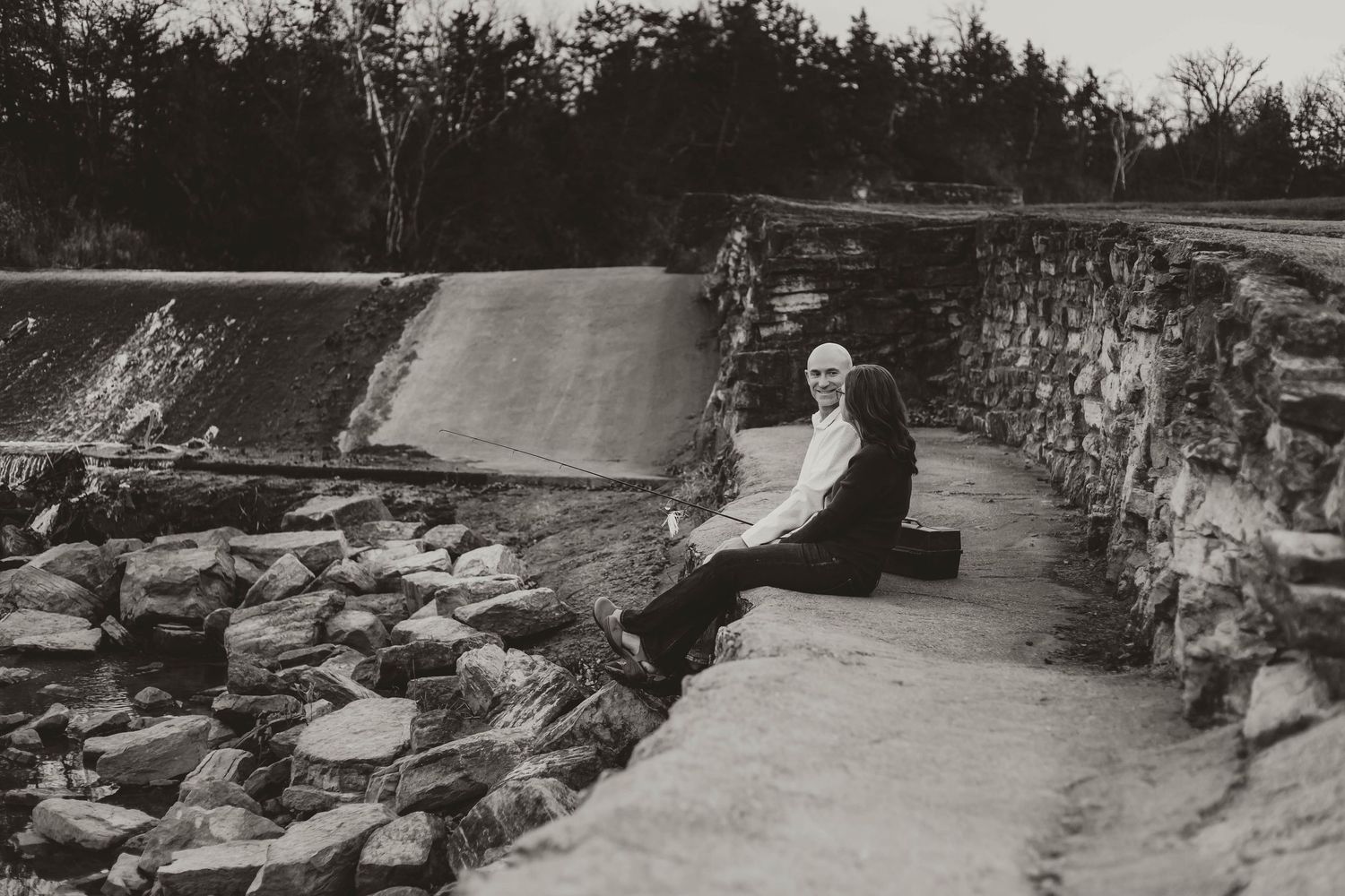 Couple fishing off retaining wall southeast minnesota