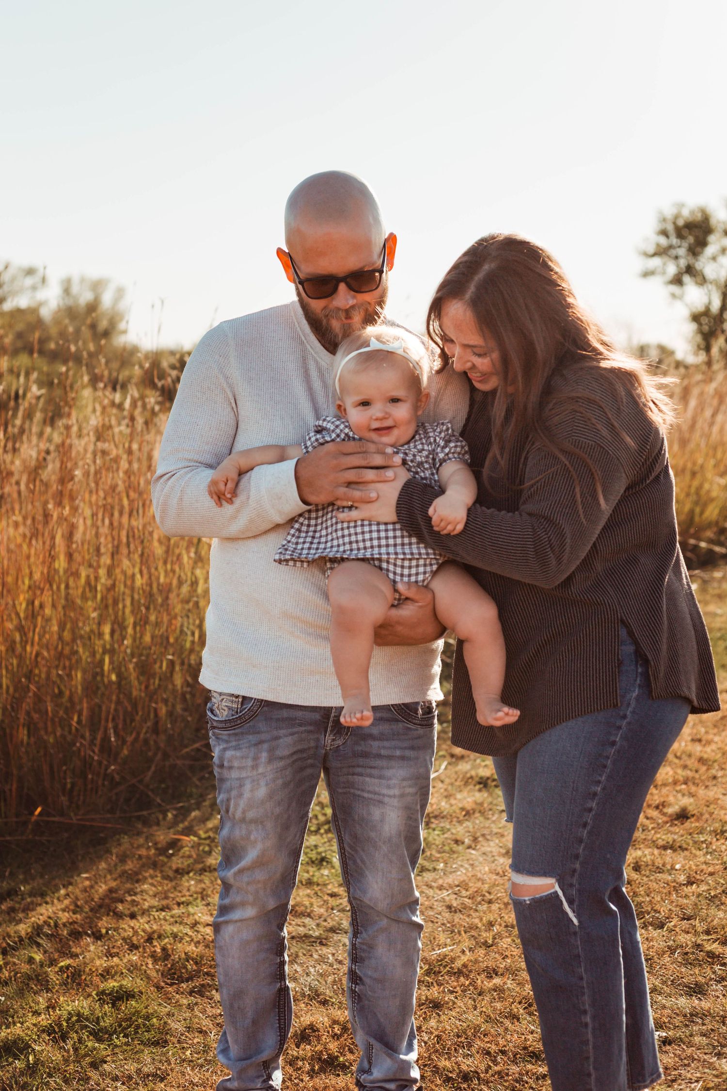 Family of 3 in sunny, grassy field Southeast Minnesota
