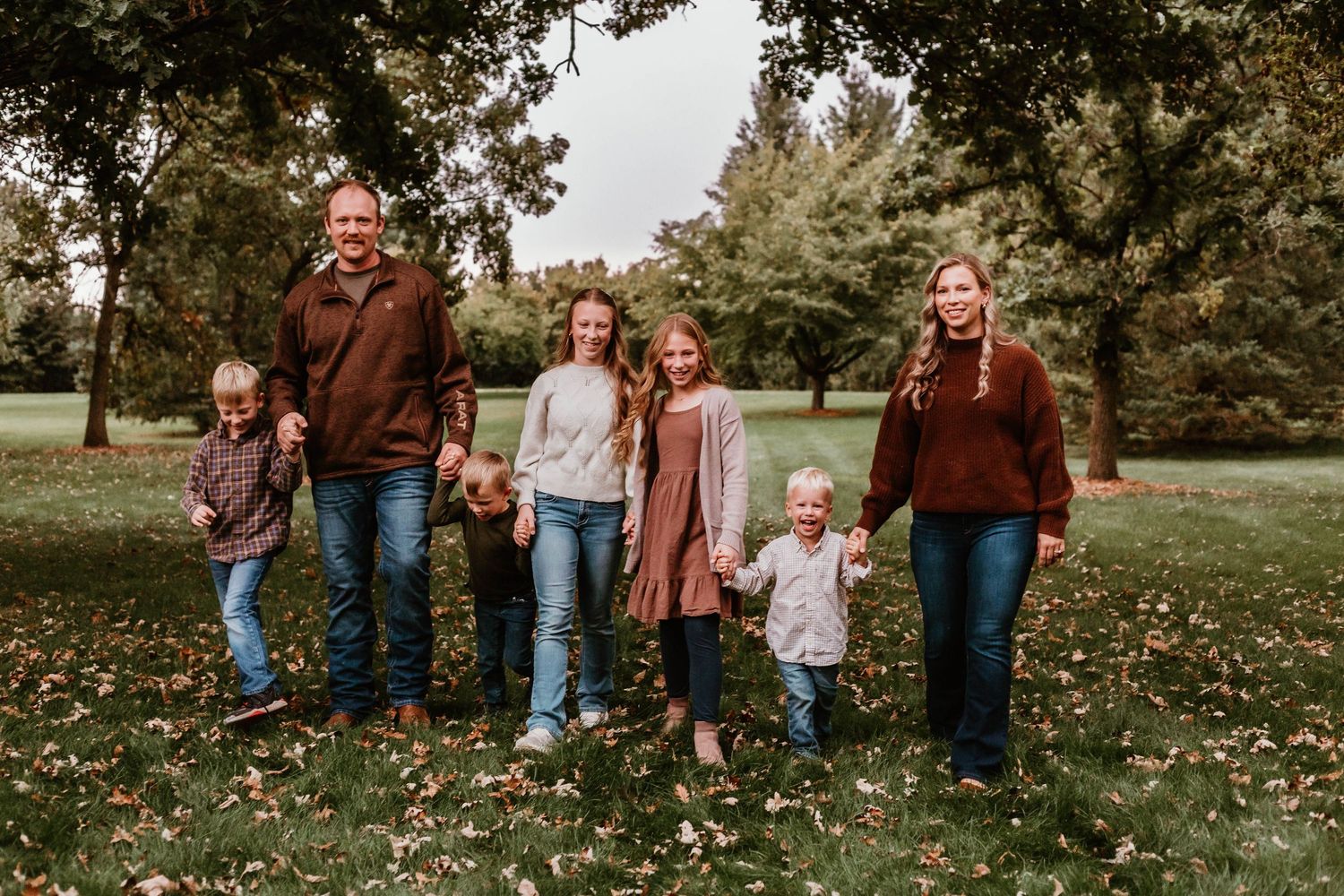 Family of 7 walking in grassy field Southeast Minnesota