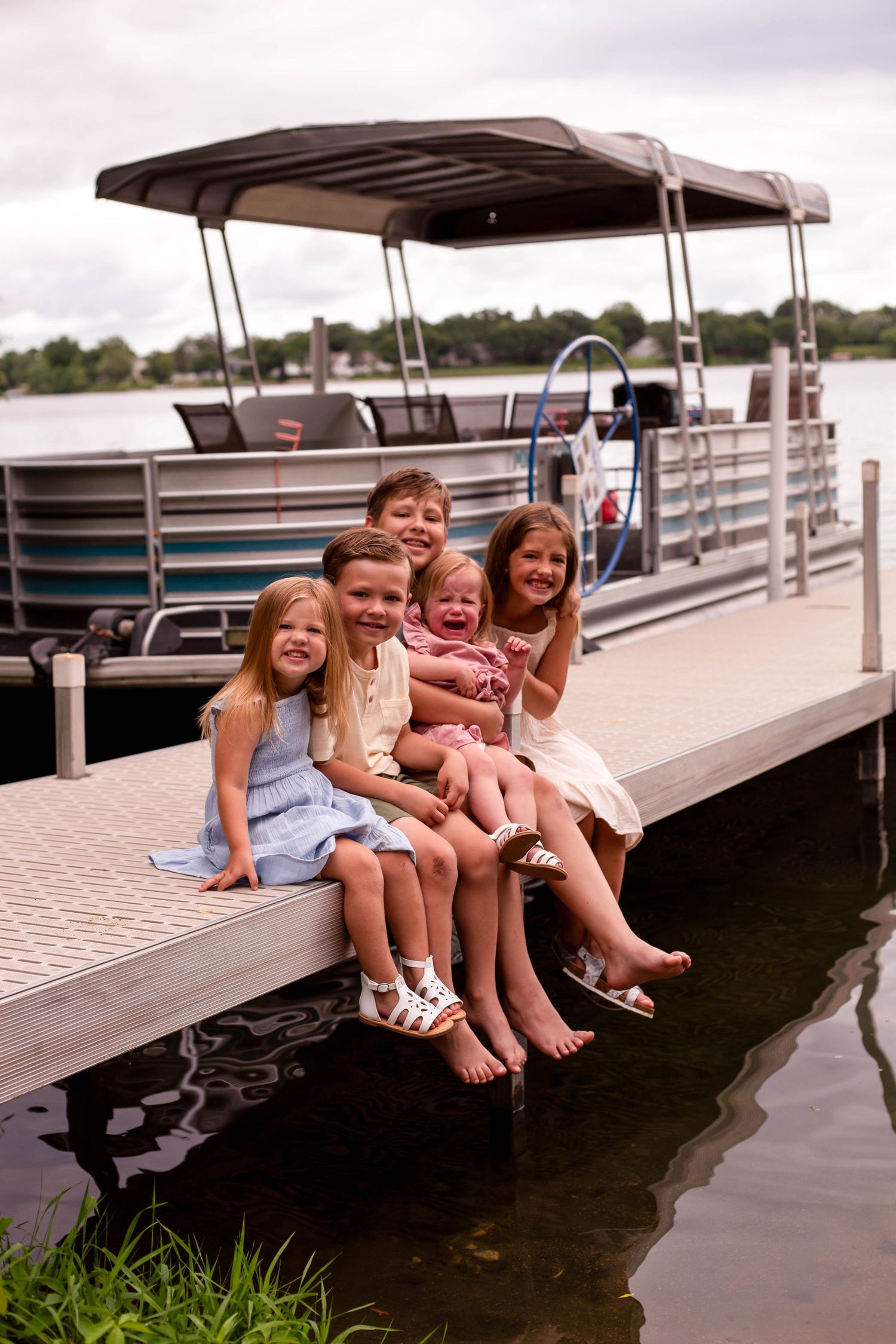 Group of kids on dock in front of lake Minnesota