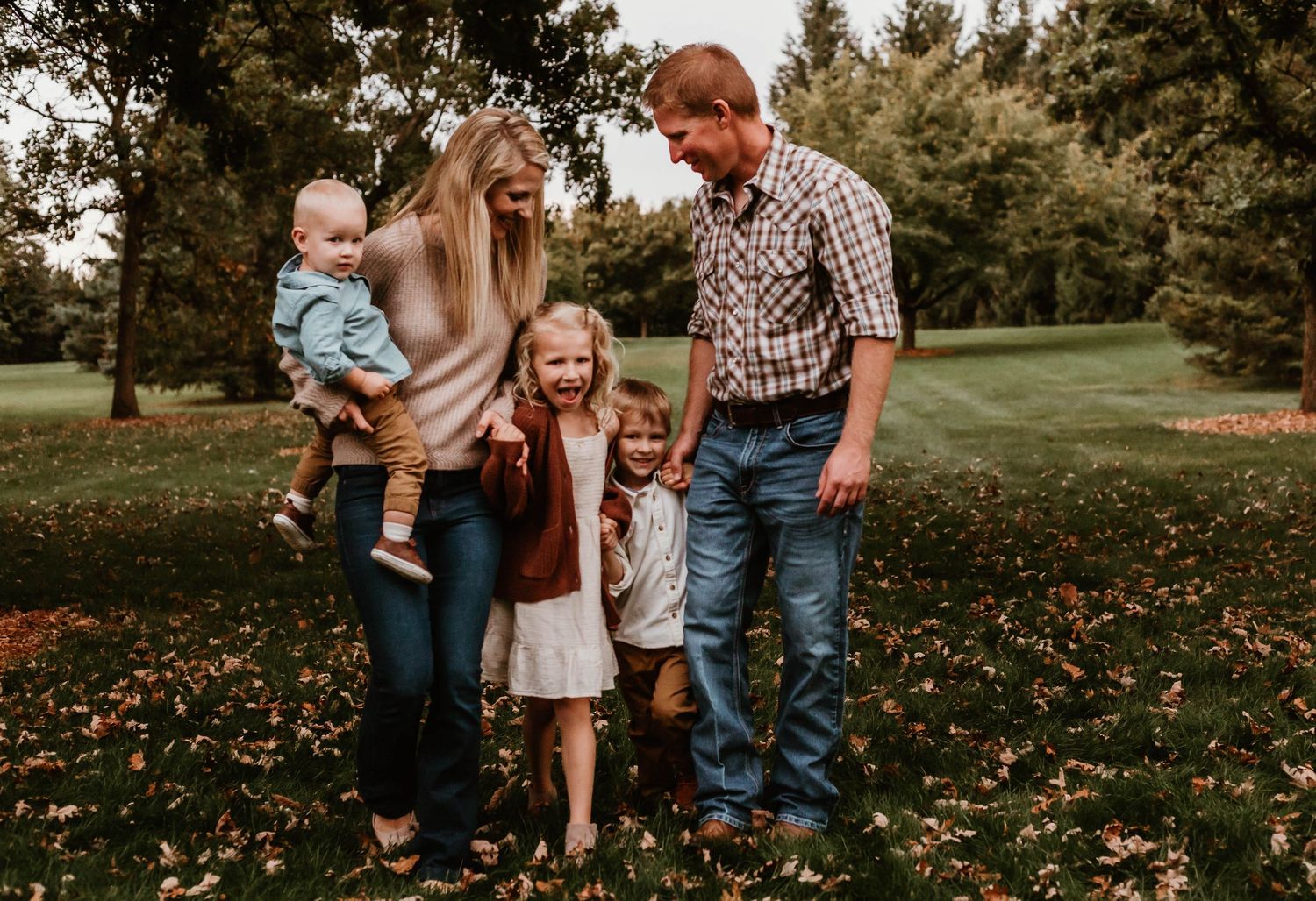Family of 5 walking in grassy field Southeast Minnesota