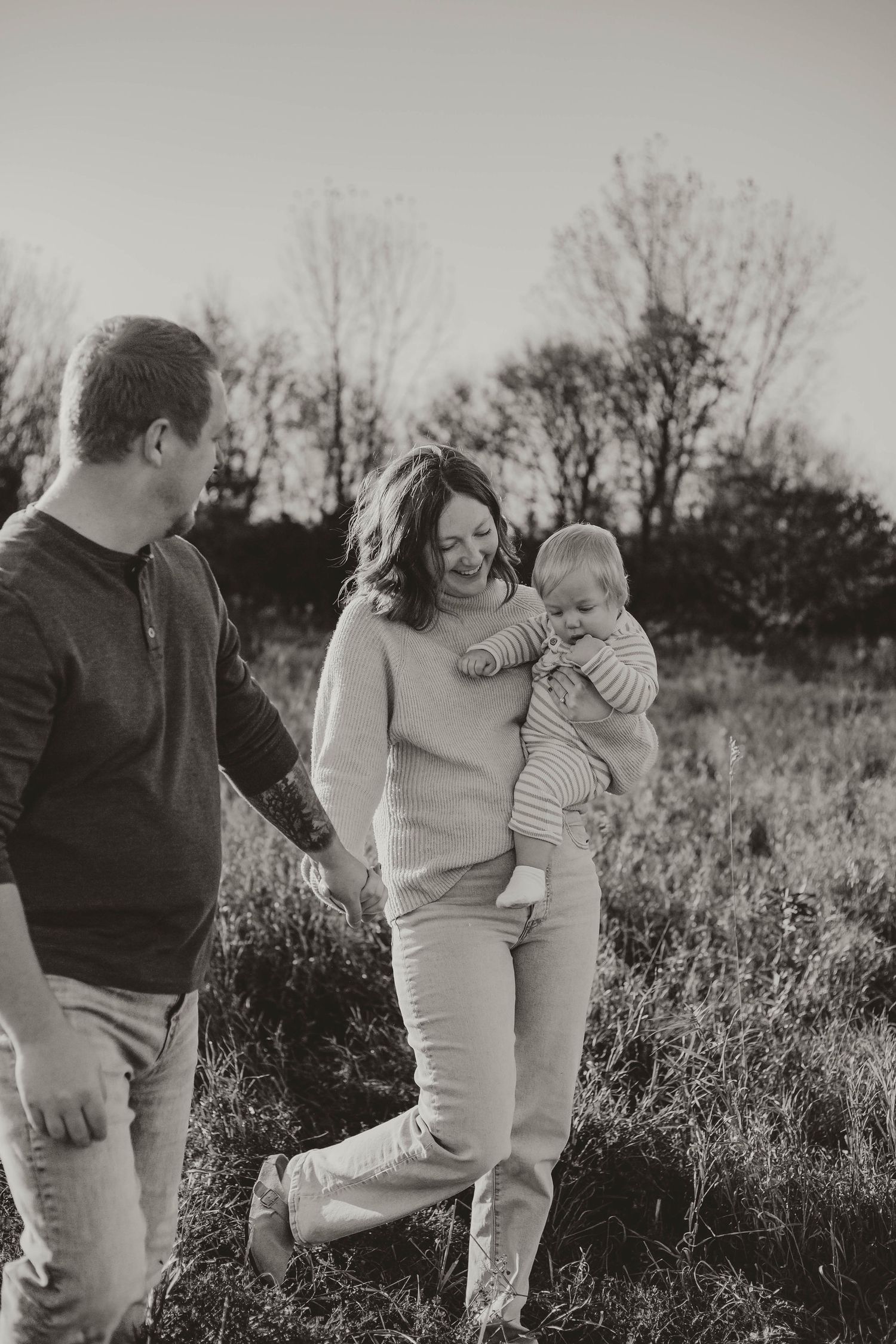 Family of 3 in grassy field Southeast Minnesota