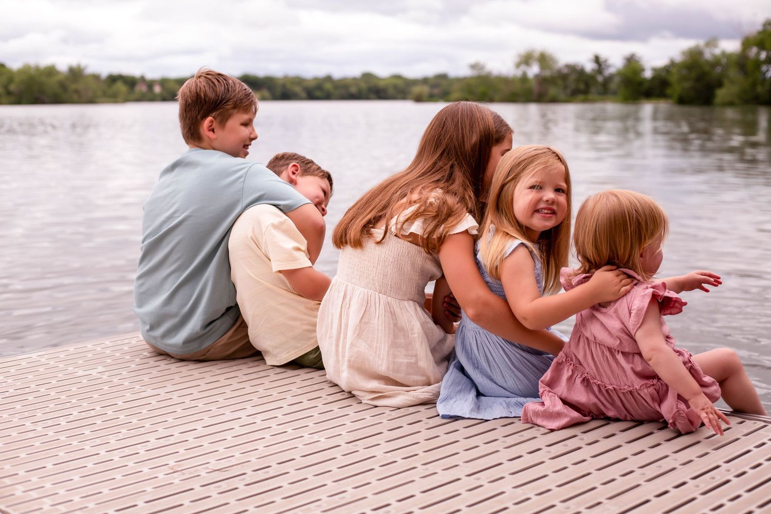 Group of kids on dock in front of lake Minnesota