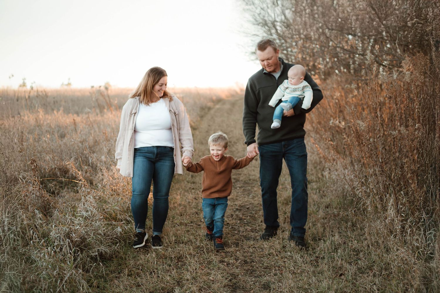 Family of 4 walking in grassy field Southeast Minnesota