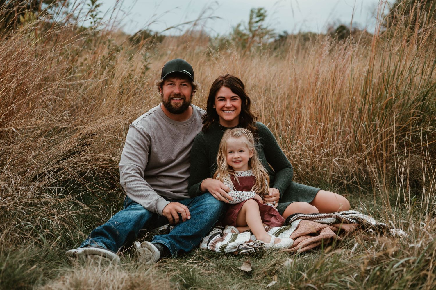 Family of 3 in grassy field Southeast Minnesota