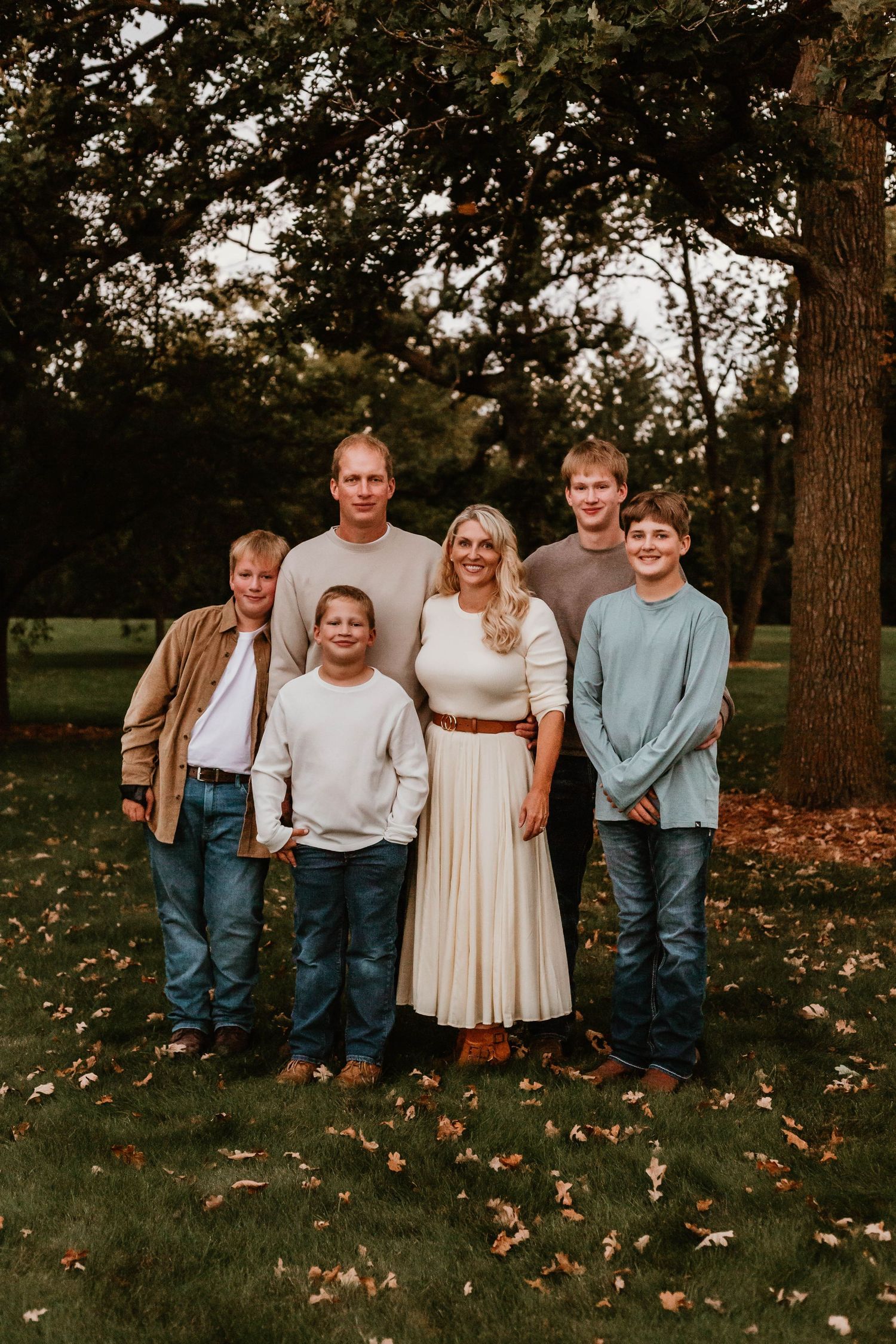 Family of 6 hugging in grassy field Southeast Minnesota